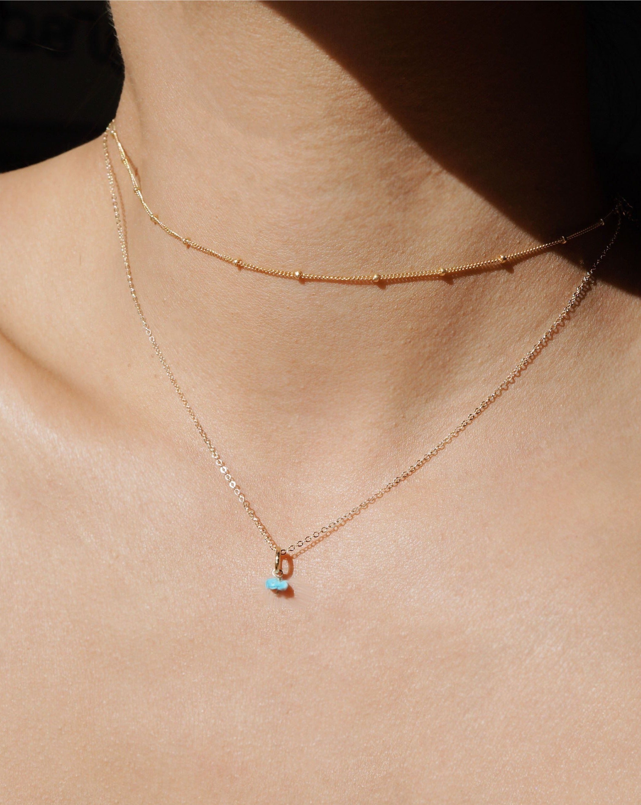 One Love Birthstone Necklace by KOZAKH. A necklace crafted in 14K Gold Filled, featuring customizable Birthstone charms and is available in 4 adjustable lengths.