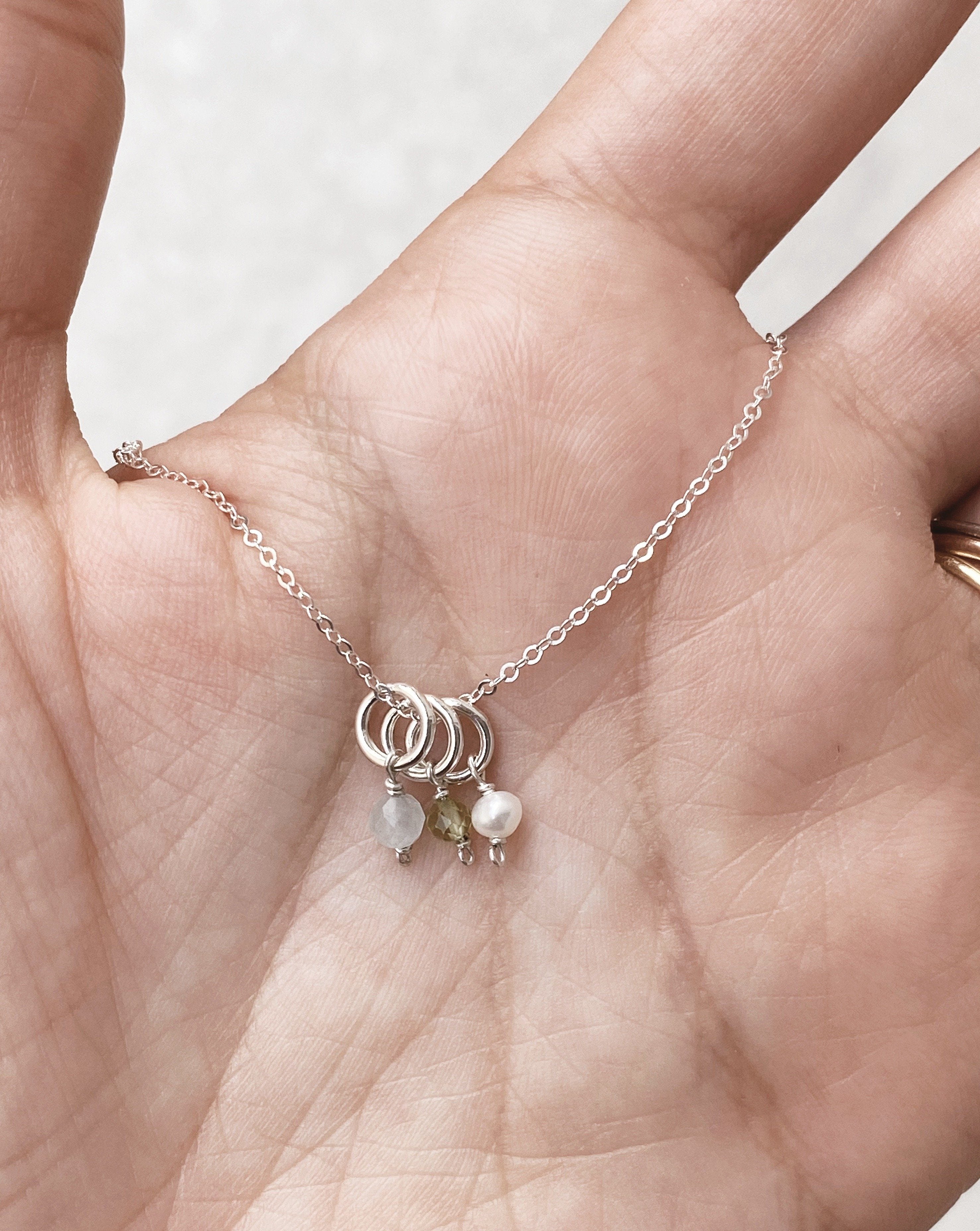 One Love Birthstone Necklace by KOZAKH. A necklace crafted in 14K Gold Filled, featuring customizable Birthstone charms and is available in 4 adjustable lengths.