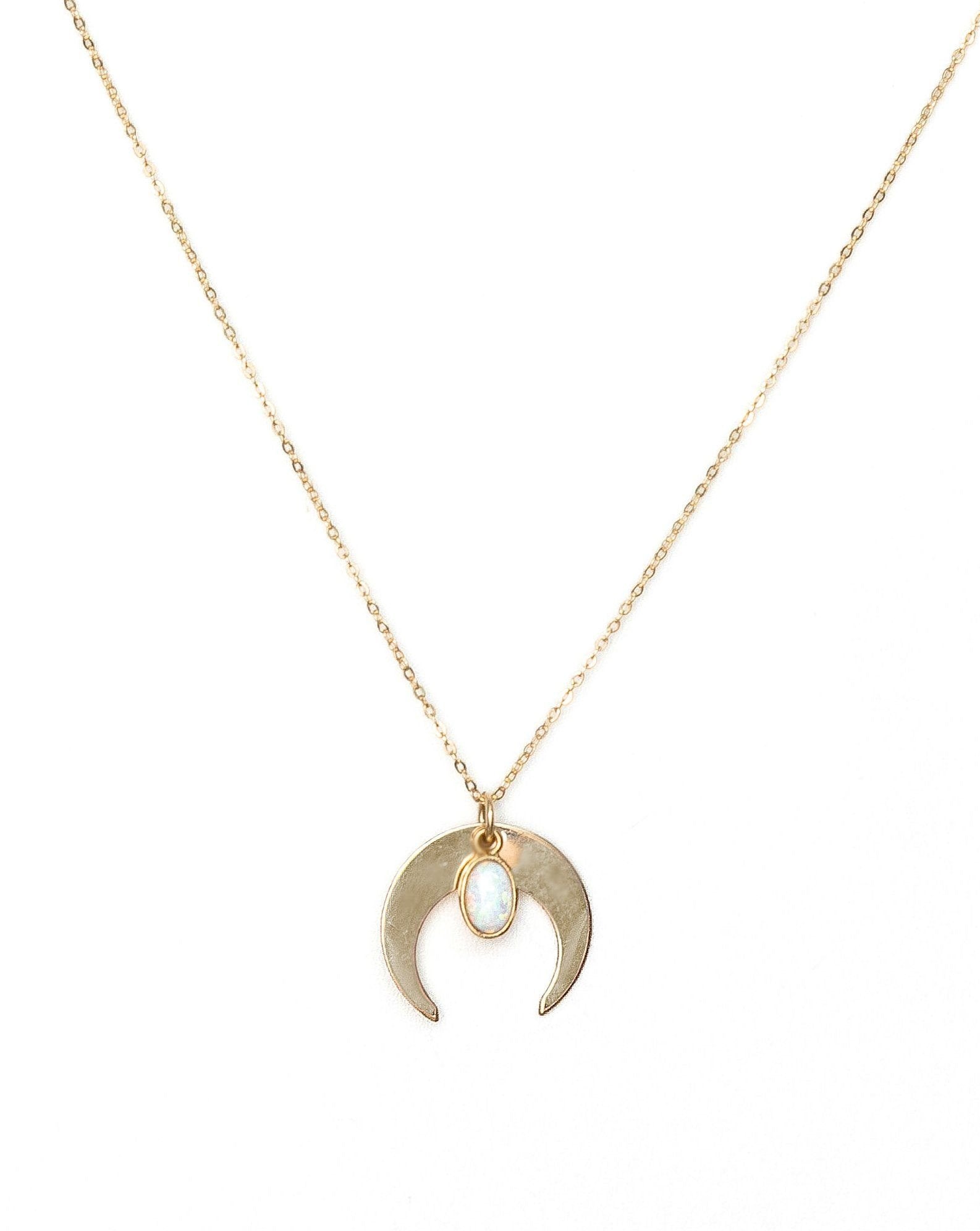 Opal Moon Necklace by KOZAKH. A 16 to 18 inch adjustable length necklace, crafted in 14K Gold Filled, featuring an oval Opal charm and a moon charm.