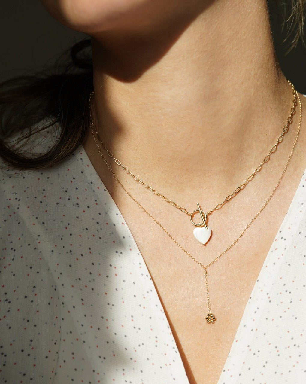 Paloma Necklace by KOZAKH. A 16 to 18 inch adjustable length, 3 inch drop lariat style necklace, crafted in 14K Gold Filled, featuring a handmade beaded daisy charm.