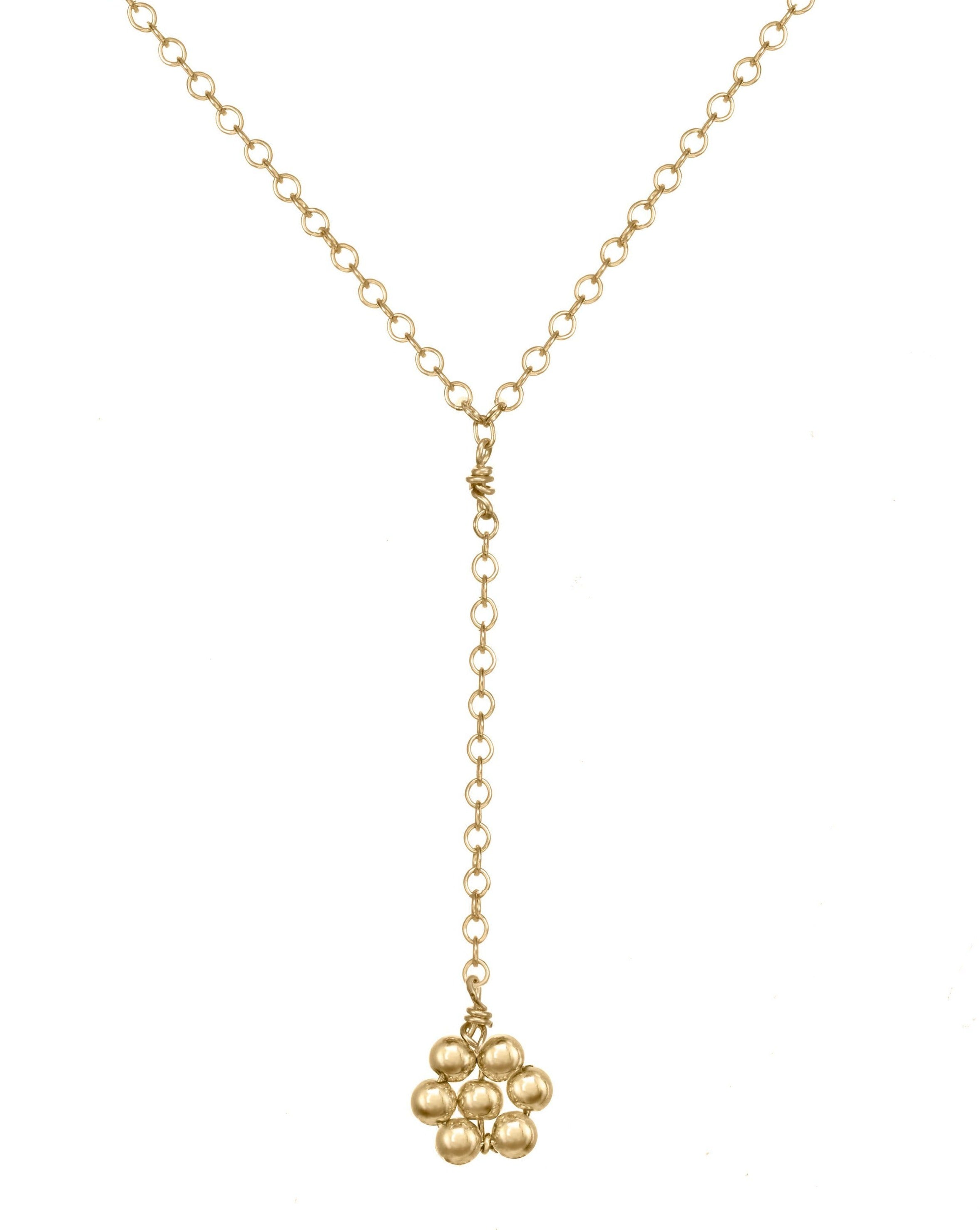 Paloma Necklace by KOZAKH. A 16 to 18 inch adjustable length, 3 inch drop lariat style necklace, crafted in 14K Gold Filled, featuring a handmade beaded daisy charm.