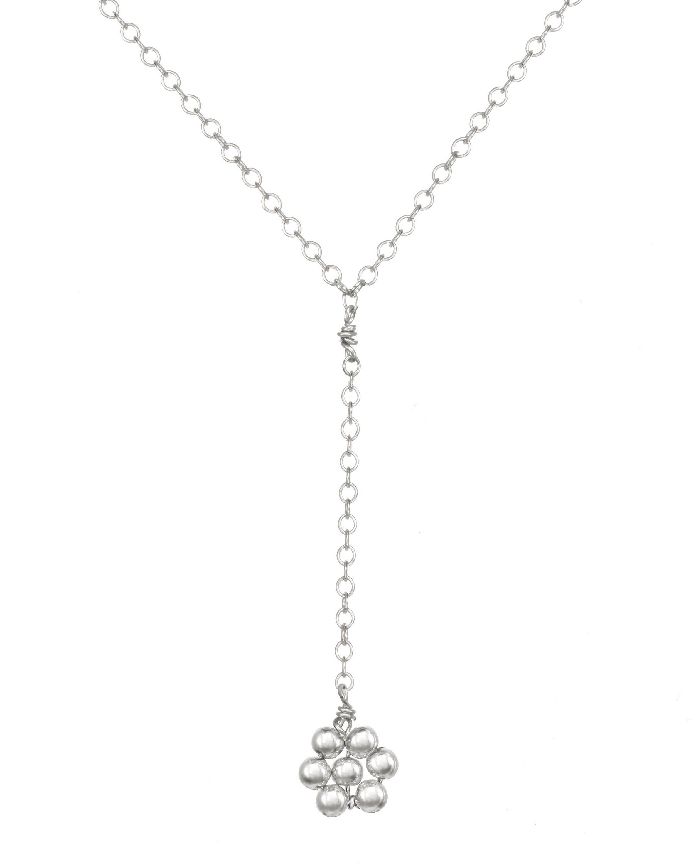 Paloma Necklace by KOZAKH. A 16 to 18 inch adjustable length, 3 inch drop lariat style necklace, crafted in Sterling Silver, featuring a handmade beaded daisy charm.