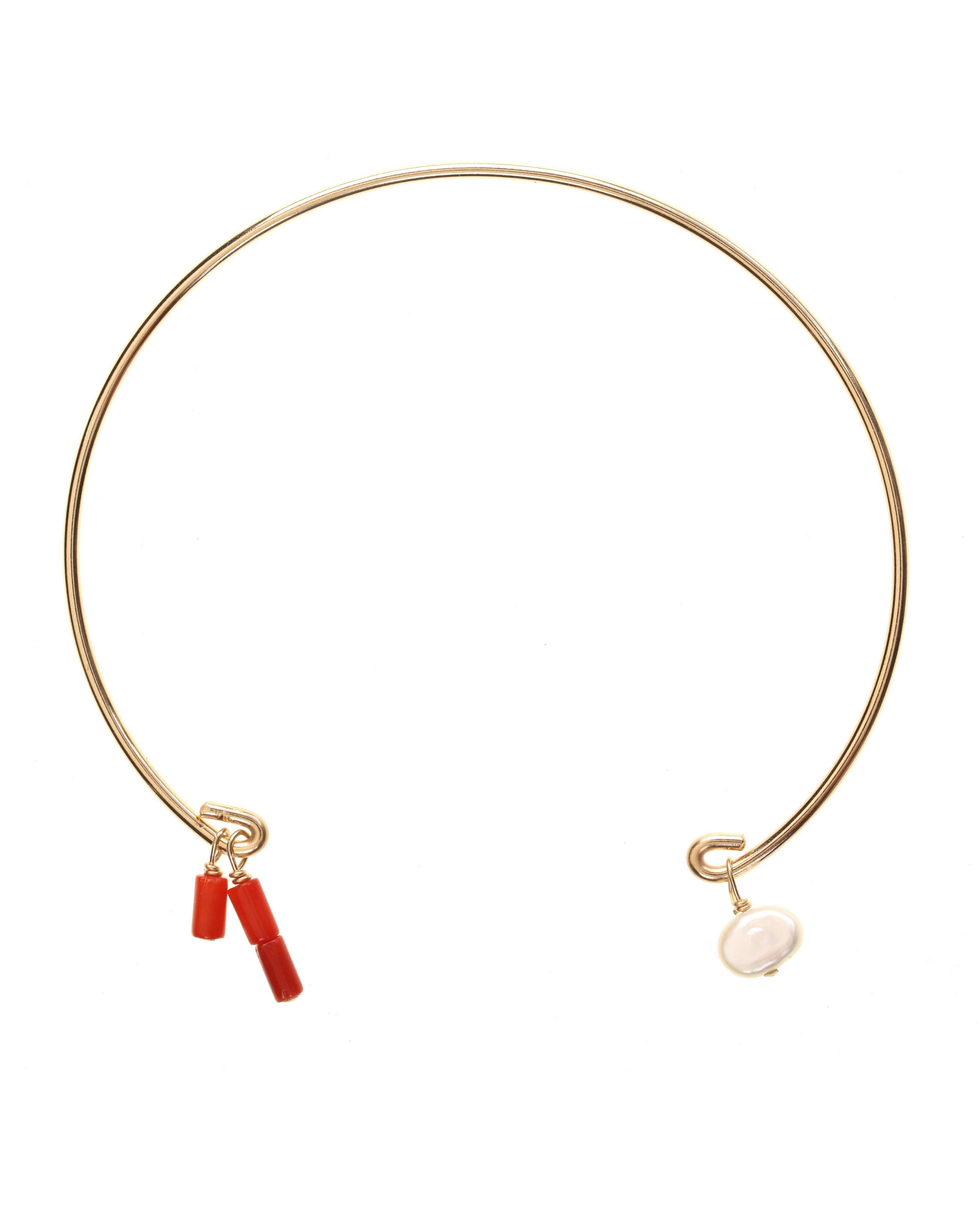 Rella Bracelet by KOZAKH. A bangle bracelet that fits a wrist of 6 to 8 inches, crafted in 14K Gold Filled, featuring dyed red coral tubes and a white irregular Pearl.