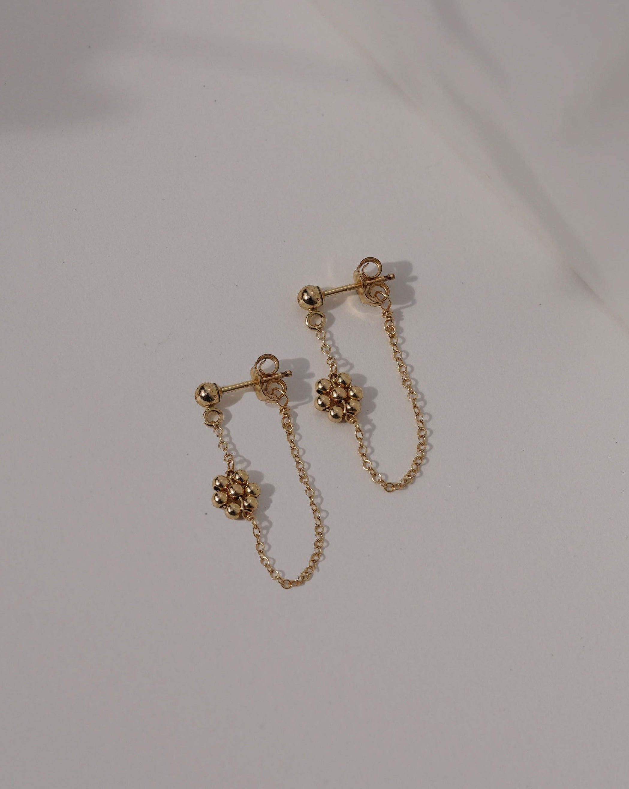 Rosana Earrings by KOZAKH. Front/back style stud closure earrings, crafted in 14K Gold Filled, featuring dangling handmade beaded daisy charms.
