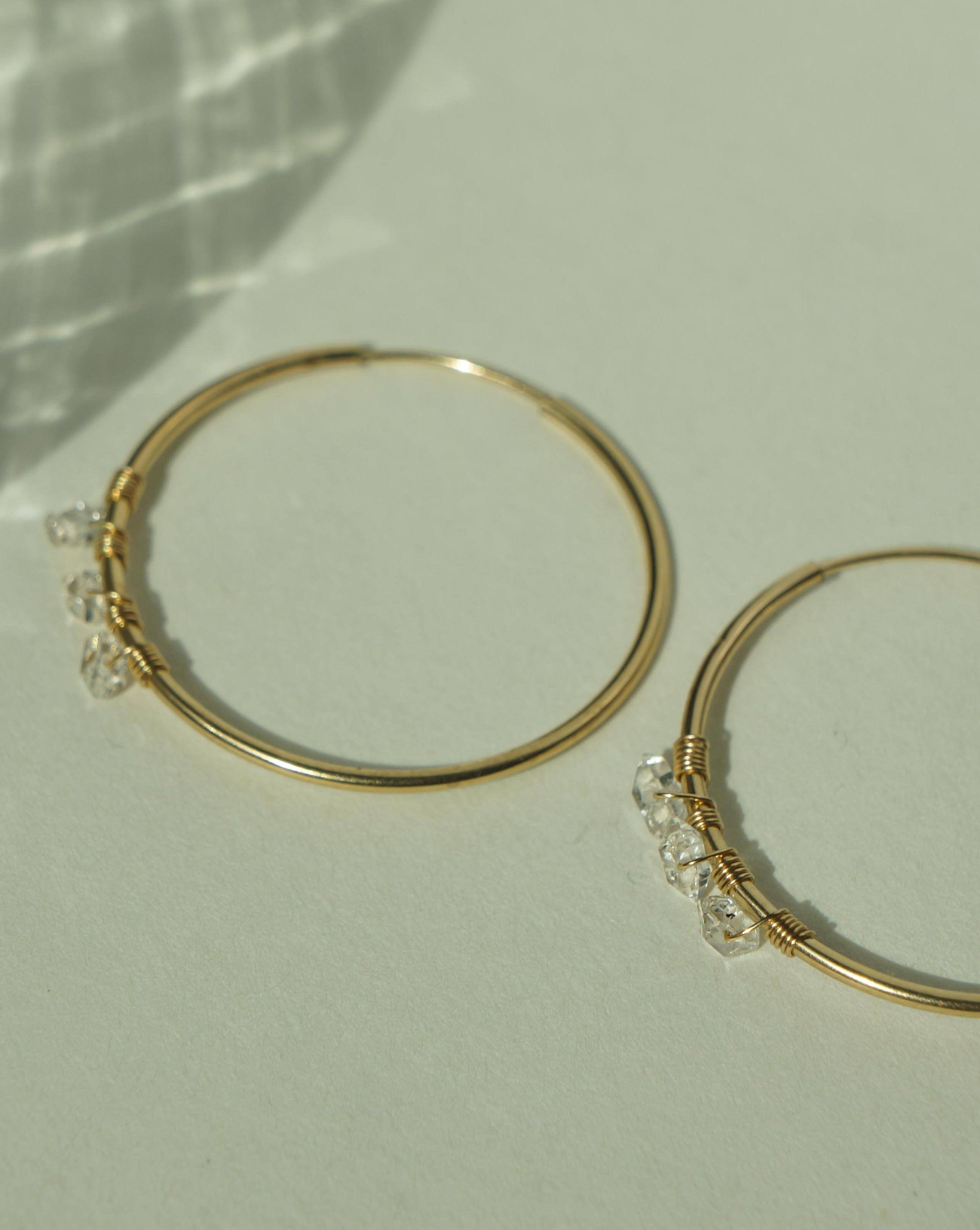 Selena Herkimer Hoop Earrings by KOZAKH. 30mm hoop earrings in 14K Gold Filled, featuring Herkimer Diamonds.