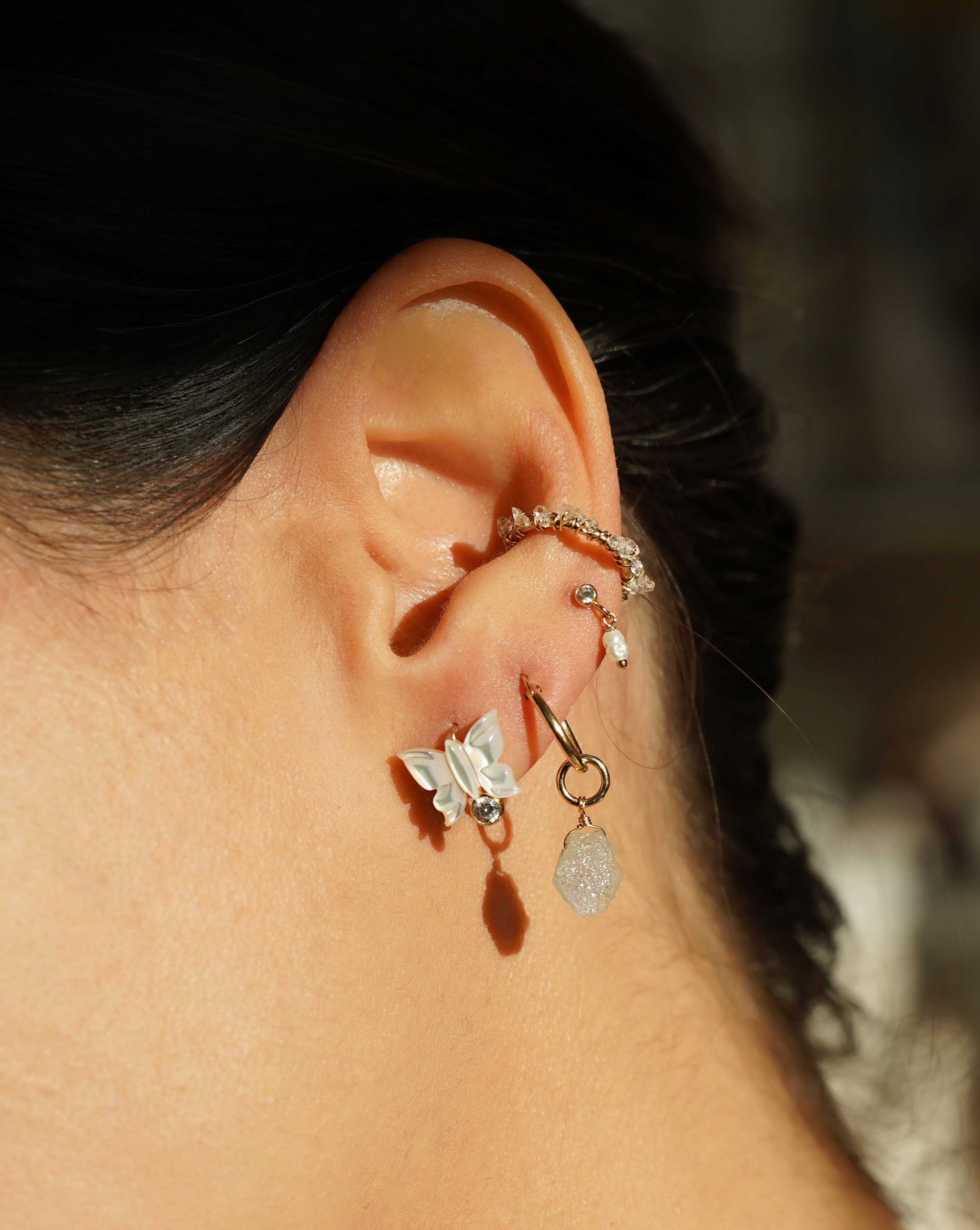 Sevyn Earrings by KOZAKH. Stud earrings, crafted in 14K Gold Filled, featuring a hand carved butterfly charm and a bezel set Cubic Zirconia.