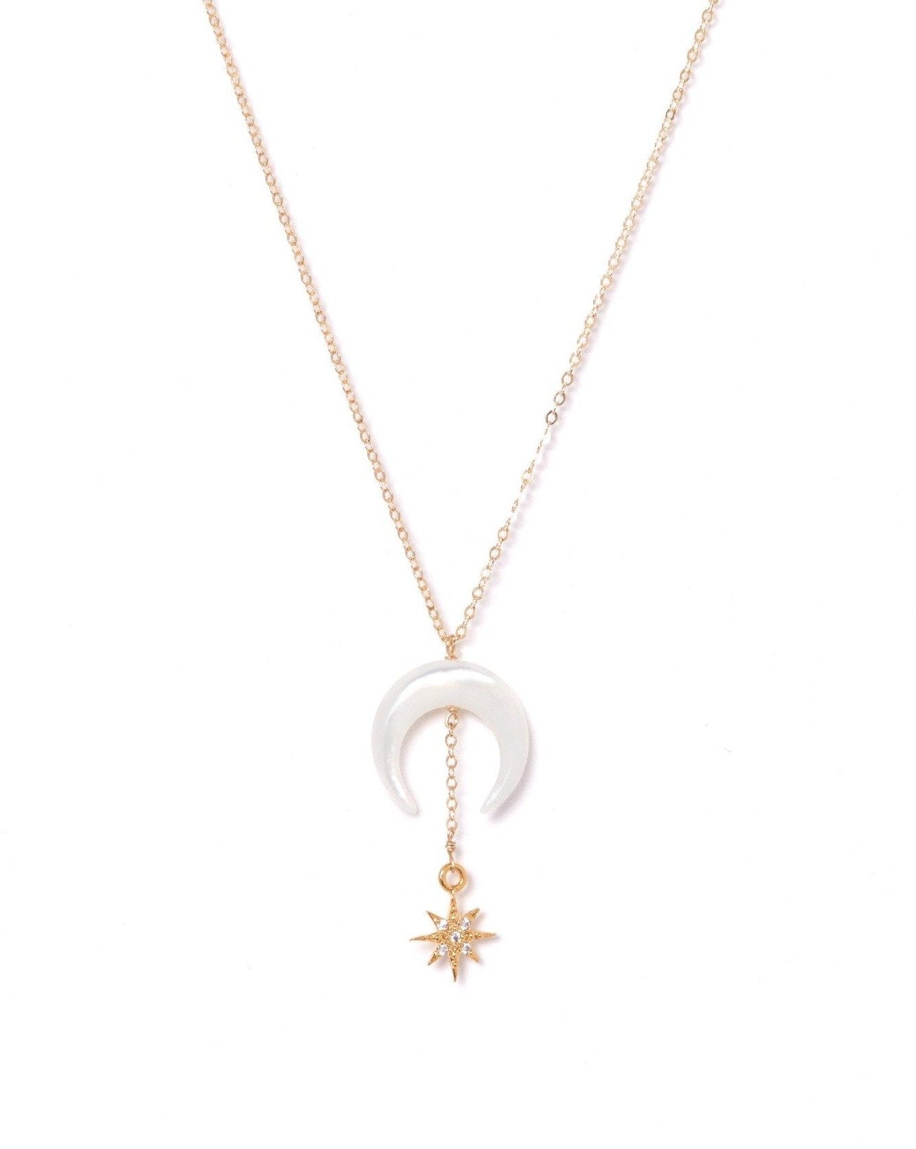 Stella Necklace by KOZAKH. A 16 to 18 inch adjustable length necklace, crafted in 14K Gold Filled, featuring a hand carved Mother of Pearl crescent moon charm and a Cubic Zirconia encrusted 6 point star.
