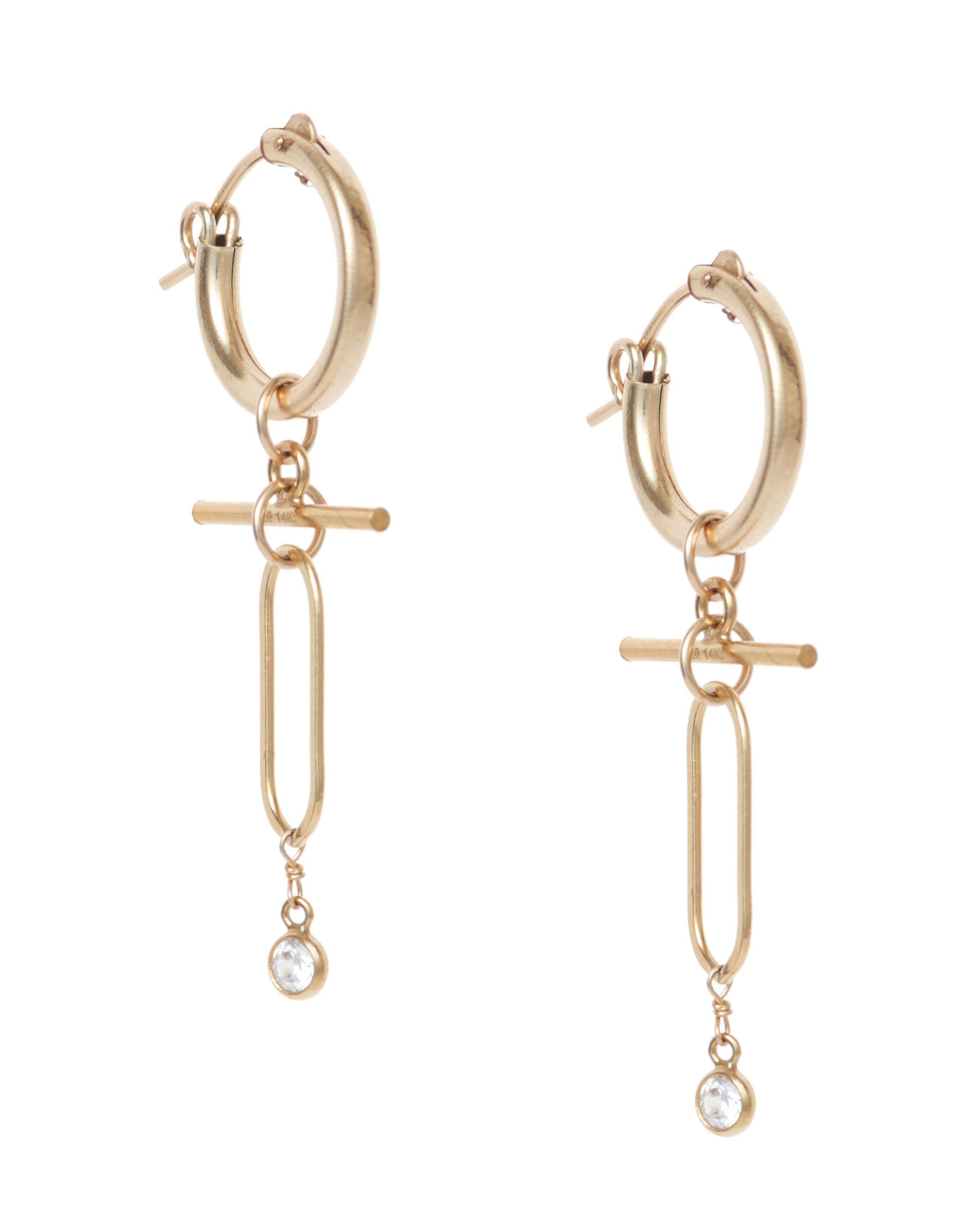 Tabetha Hoops Earrings by KOZAKH. 15mm snap closure hoop earrings, with 1 inch drop length, crafted in 14K Gold Filled, featuring a dangling horizontal bar and a 3mm Cubic Zirconia Bezel.