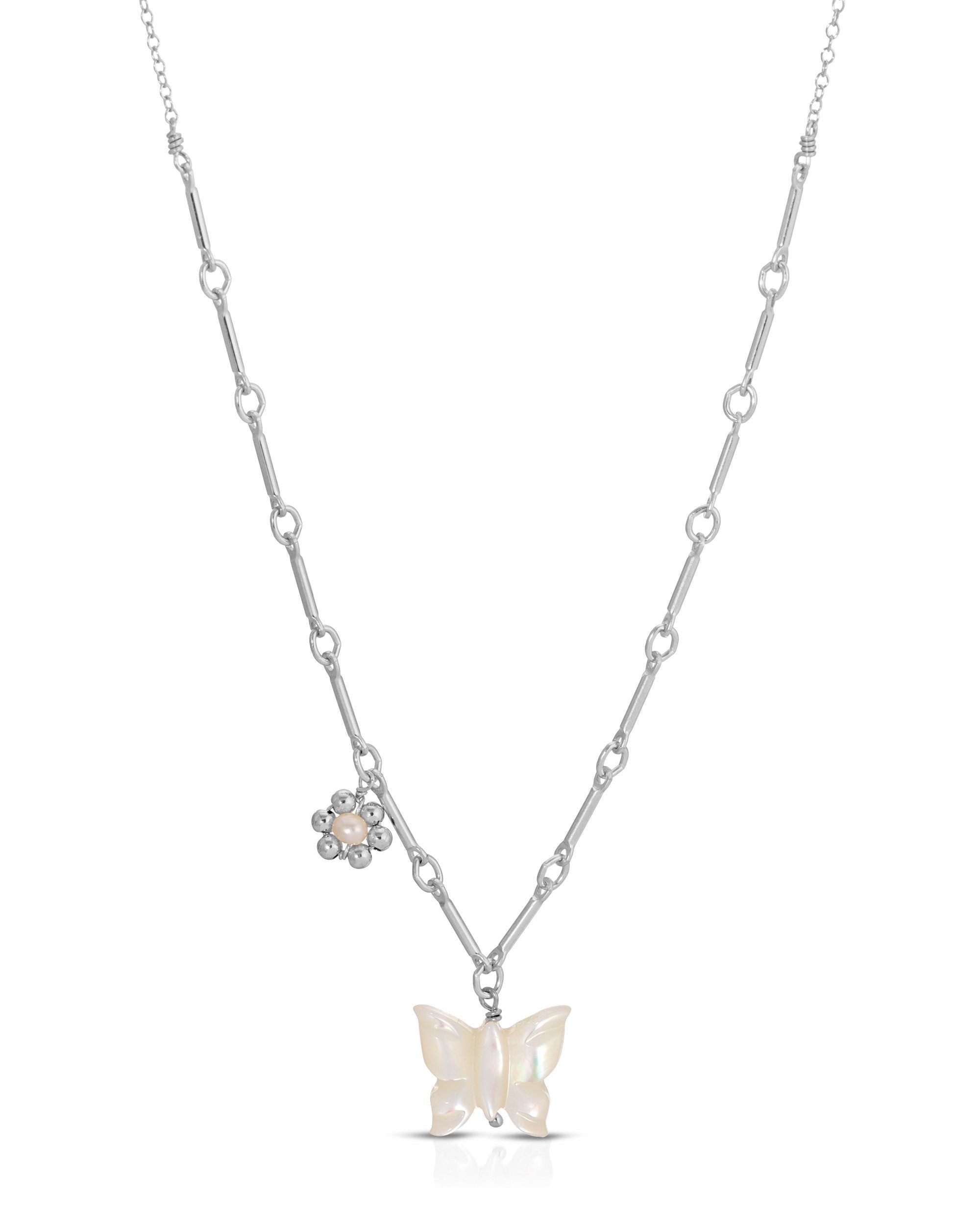 Tinley Necklace by KOZAKH. A 16 to 18 inch adjustable length necklace, with flat cable chain on top half and bar link chain on bottom half, crafted in Sterling Silver, featuring a hand-carved Mother of Pearl butterfly charm and a handmade silver beaded daisy with 2mm pearl in the center.