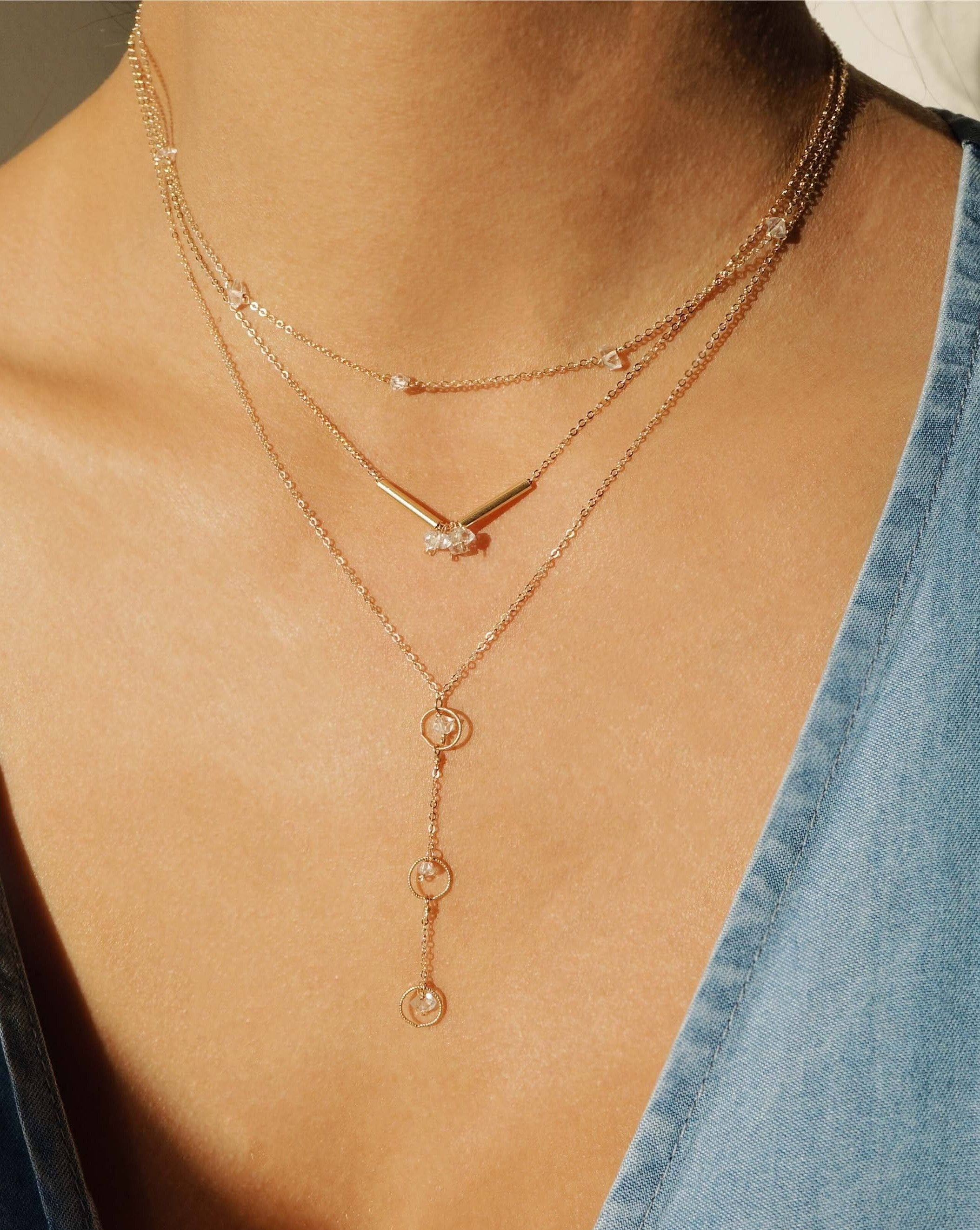 Tre Amos Necklace by KOZAKH. A 16 to 18 inch adjustable length, 1 1/2 inches drop lariat style necklace, crafted in 14K Gold Filled, featuring Herkimer Diamonds.