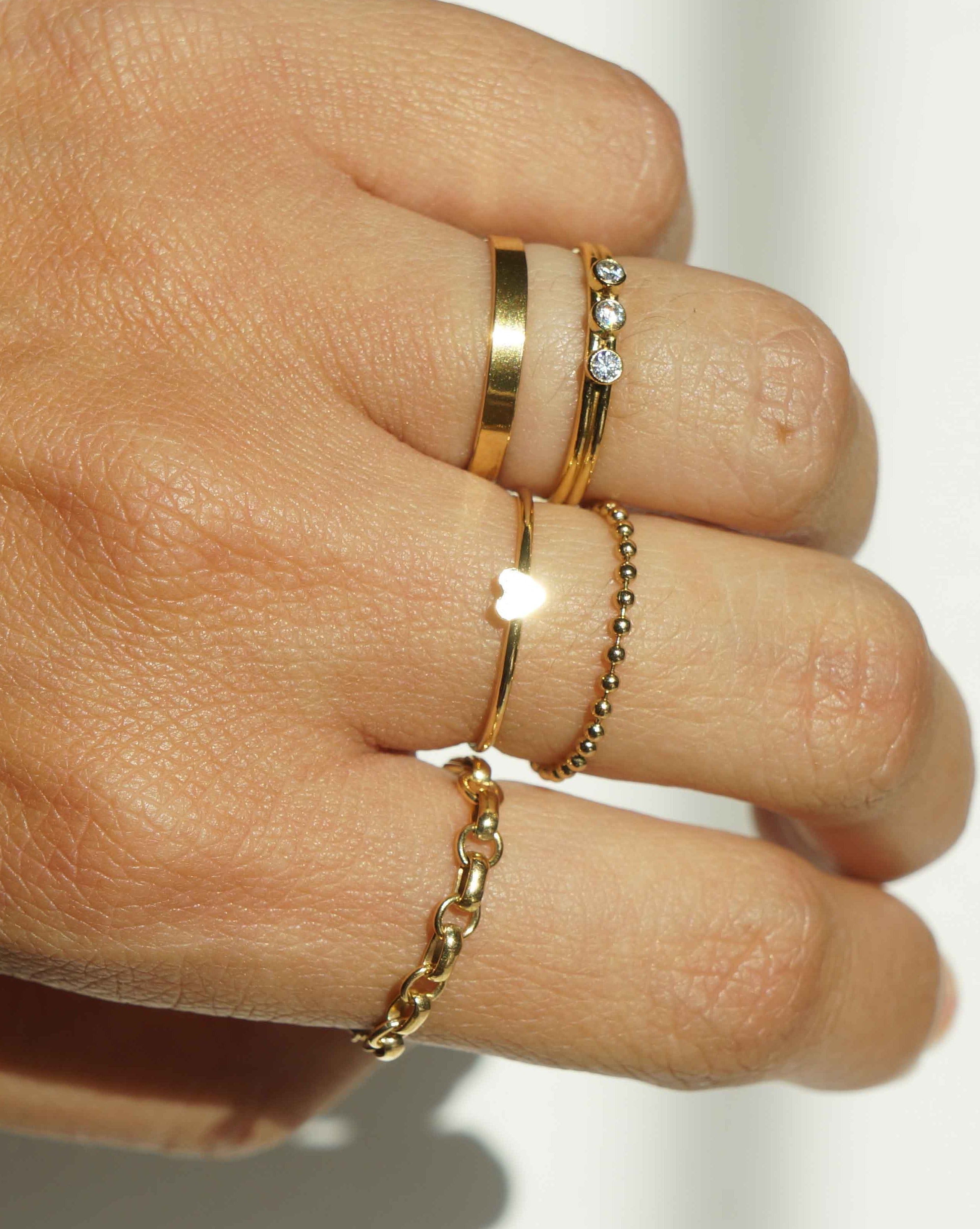 Tres Dia Ring by KOZAKH. A 1mm double band, crafted in 14K Gold Filled, featuring three 2mm Cubic Zirconias.