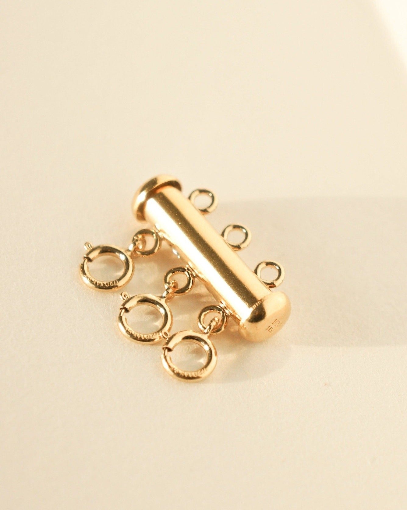 Triple Layering Clasp by KOZAKH. A 14K Gold Filled clasp that atttaches up to 3 necklaces.