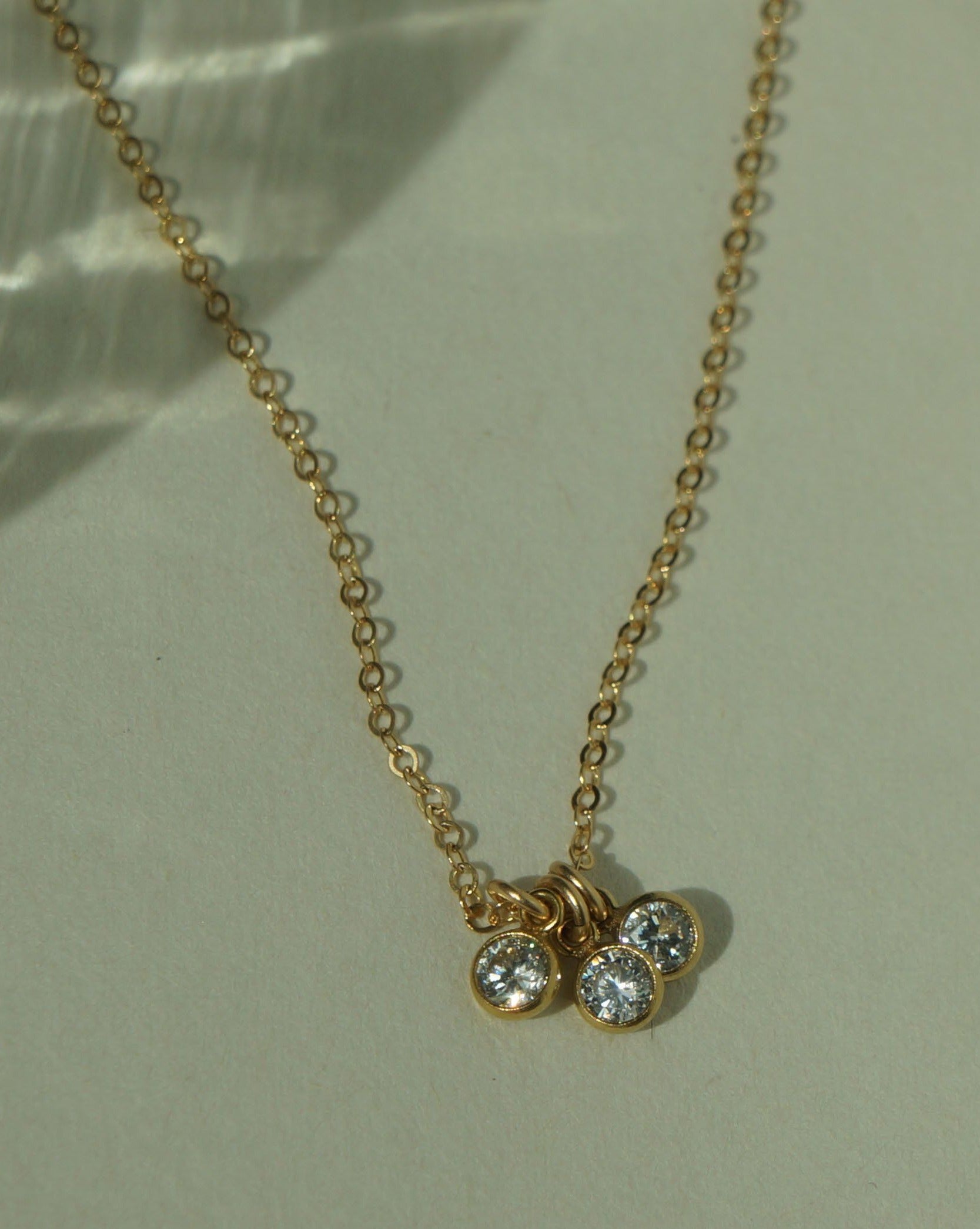 Trizare Necklace by KOZAKH. A 16 to 18 inch adjustable length necklace, crafted in 14K Gold Filled, featuring 3mm Cubic Zirconia bezels.