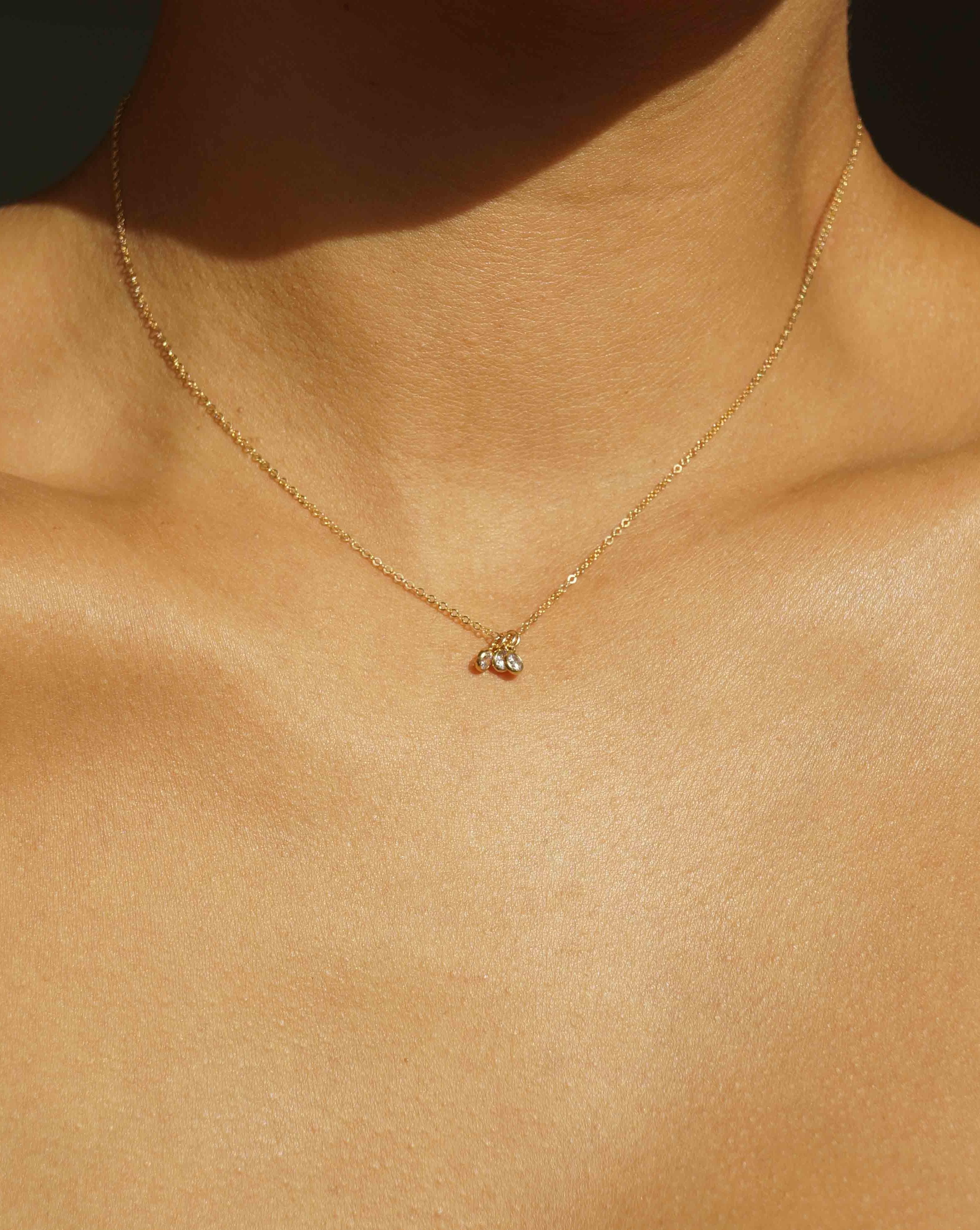 Trizare Necklace by KOZAKH. A 16 to 18 inch adjustable length necklace, crafted in 14K Gold Filled, featuring 3mm Cubic Zirconia bezels.