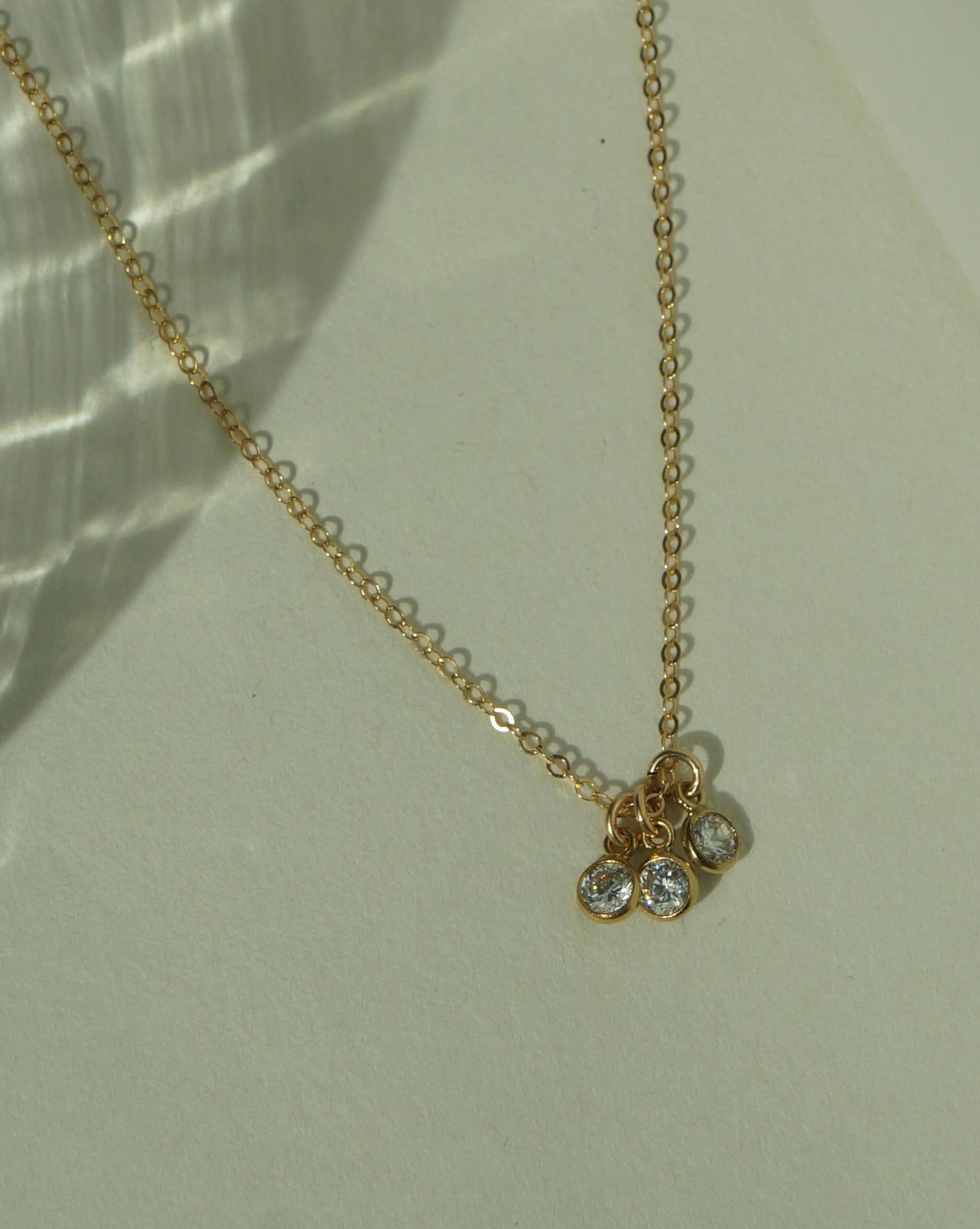 Trizare Necklace by KOZAKH. A 16 to 18 inch adjustable length necklace, crafted in 14K Gold Filled, featuring 3mm Cubic Zirconia bezels.