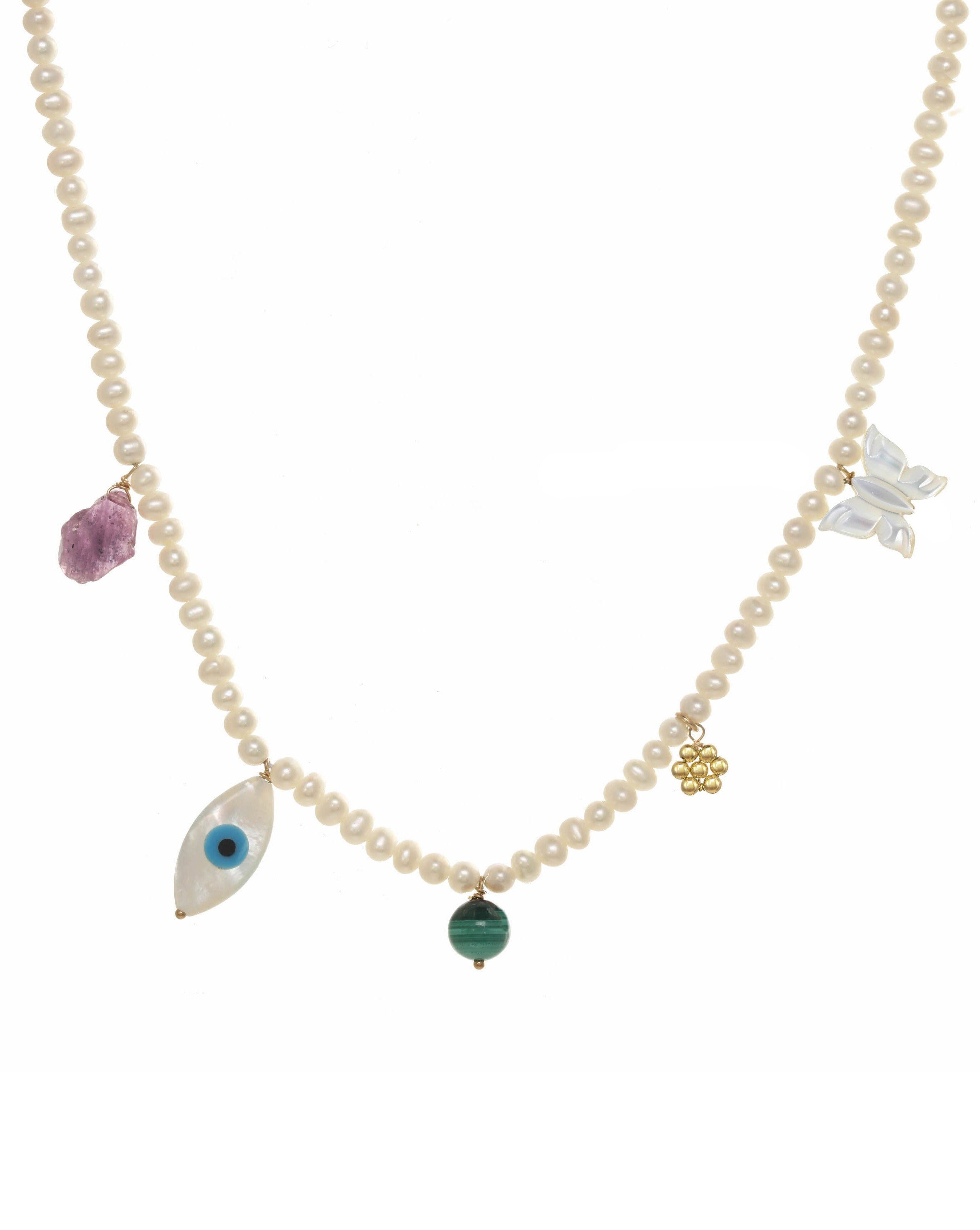Valery Necklace by KOZAKH. A 16 to 18 inch adjustable length necklace, with 16 inch strand of 3mm Freshwater Pearls, clasp crafted in 14K Gold Filled, featuring Pink Tourmaline slice, Mother of Pearl butterfly charm, smooth round Malachite gemstone, Mother of Pearl eye charm, and handmade gold beaded daisy charm.