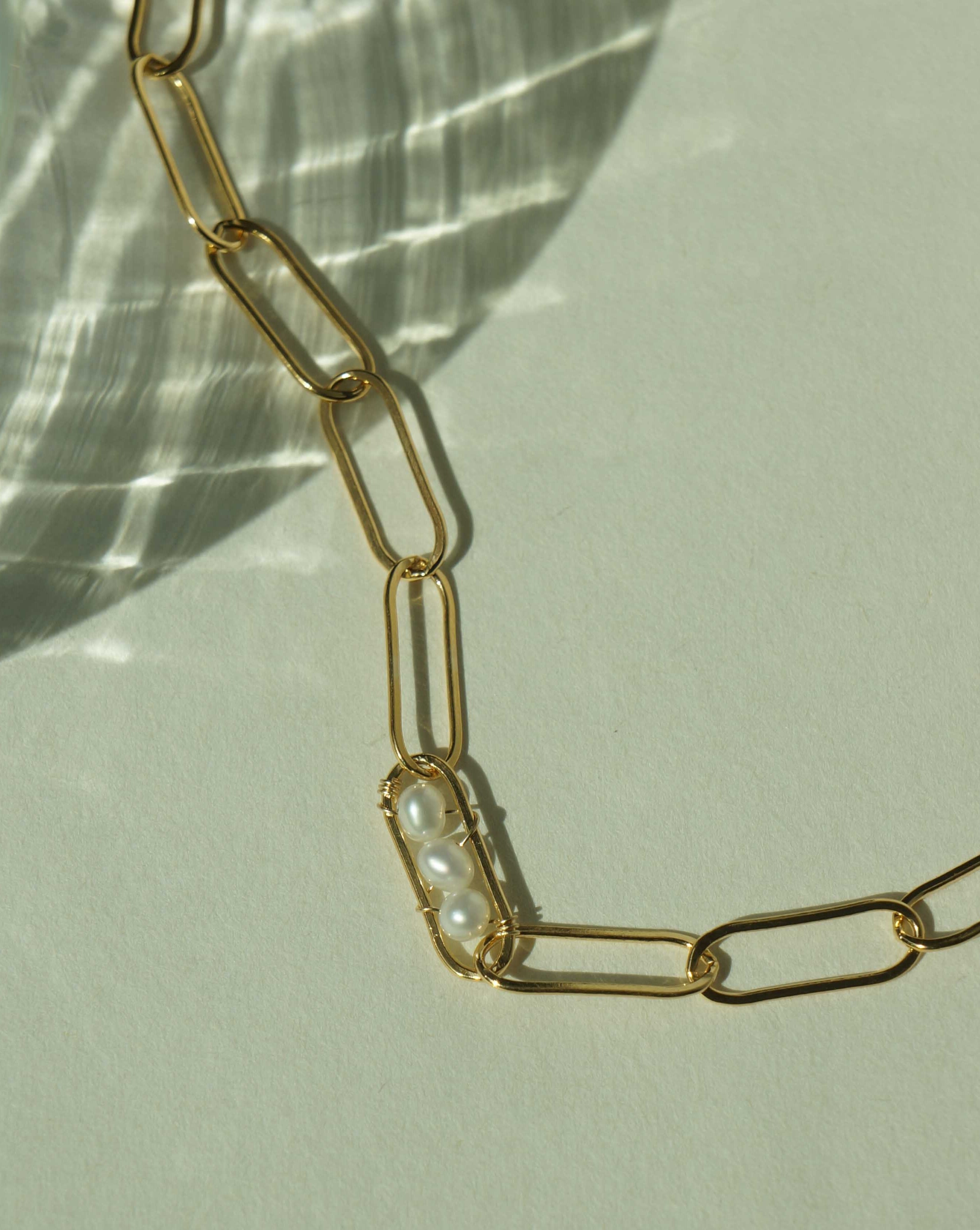 Vanessa Necklace by KOZAKH. A 14 to 16 inch adjustable length, flat link chain necklace, crafted in 14K Gold Filled, featuring 3mm to 4mm white pearls.