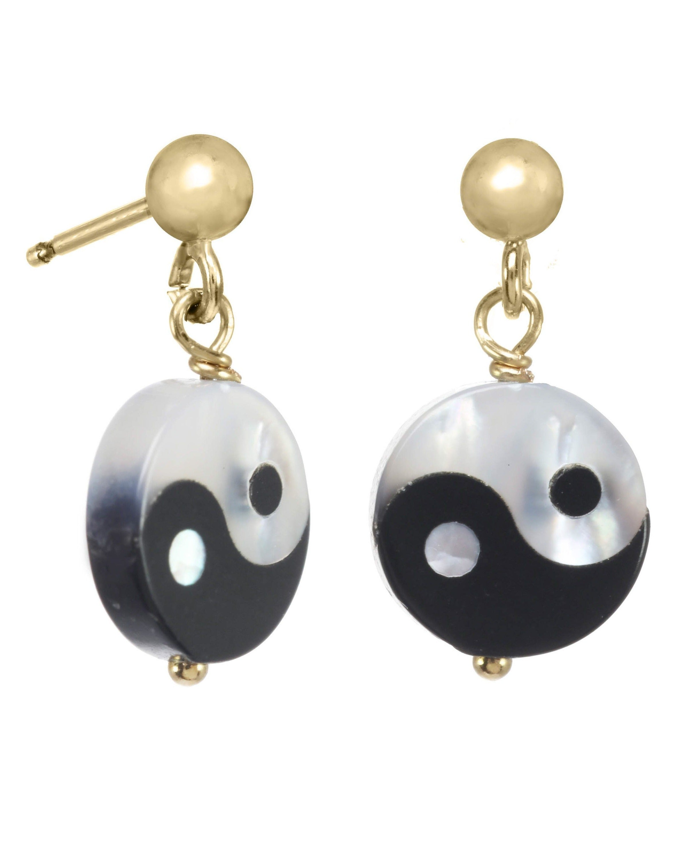 Yin Yang Earrings by KOZAKH. 3mm Ball stud earrings with 0.5 inch drop length, crafted in 14K Gold Filled, featuring a hand carved Mother of Pearl Yin Yang charm.