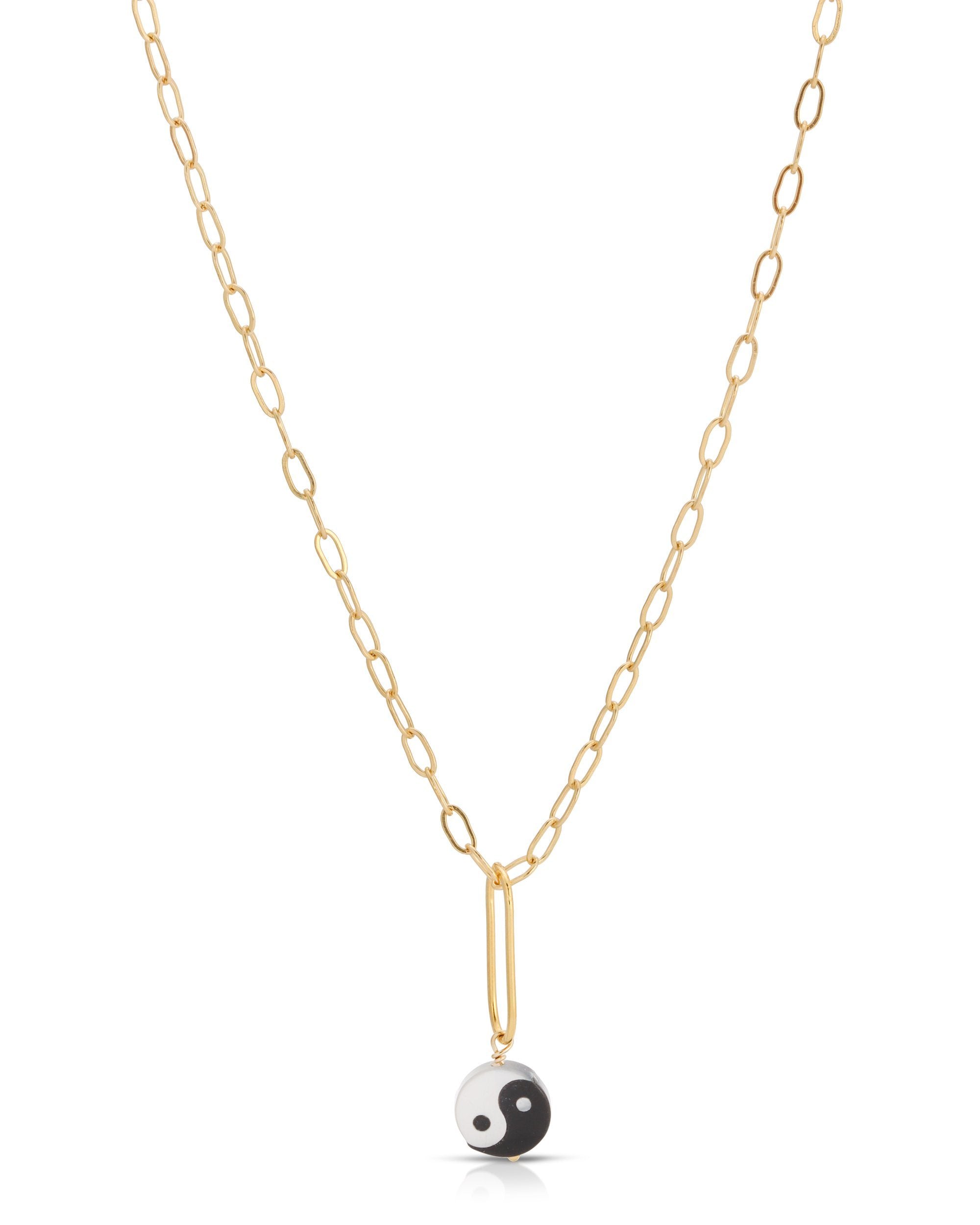 Yin Yang Necklace by KOZAKH. A 16 to 18 inch adjustable length, flat link cable chain necklace, crafted in 14K Gold Filled, featuring a hand carved Mother of pearl Yin Yang charm.