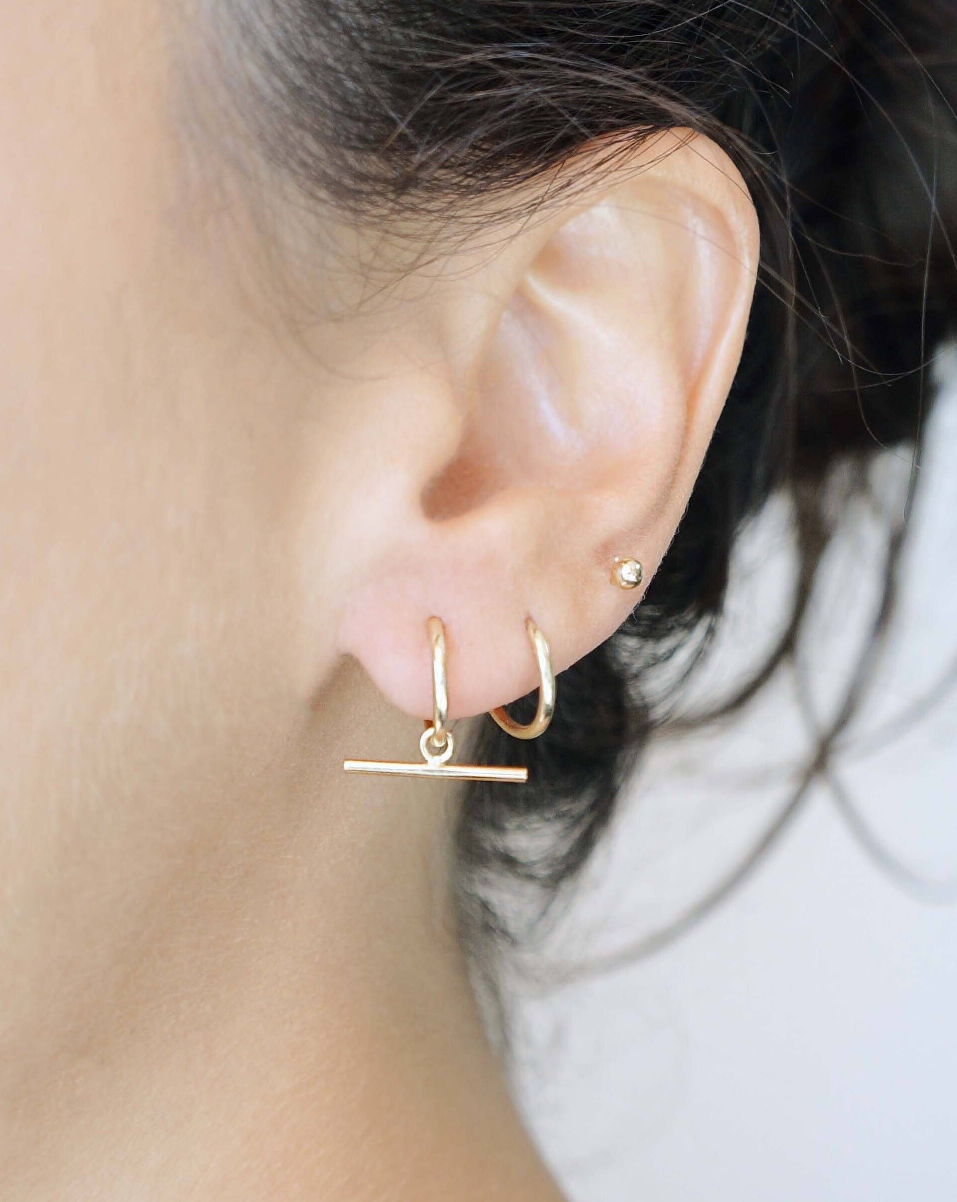 Arkis Earrings Earrings by KOZAKH. 12mm hoop earrings, crafted in 14K Gold Filled,  with seamless closure and with hanging horizontal bar stick.