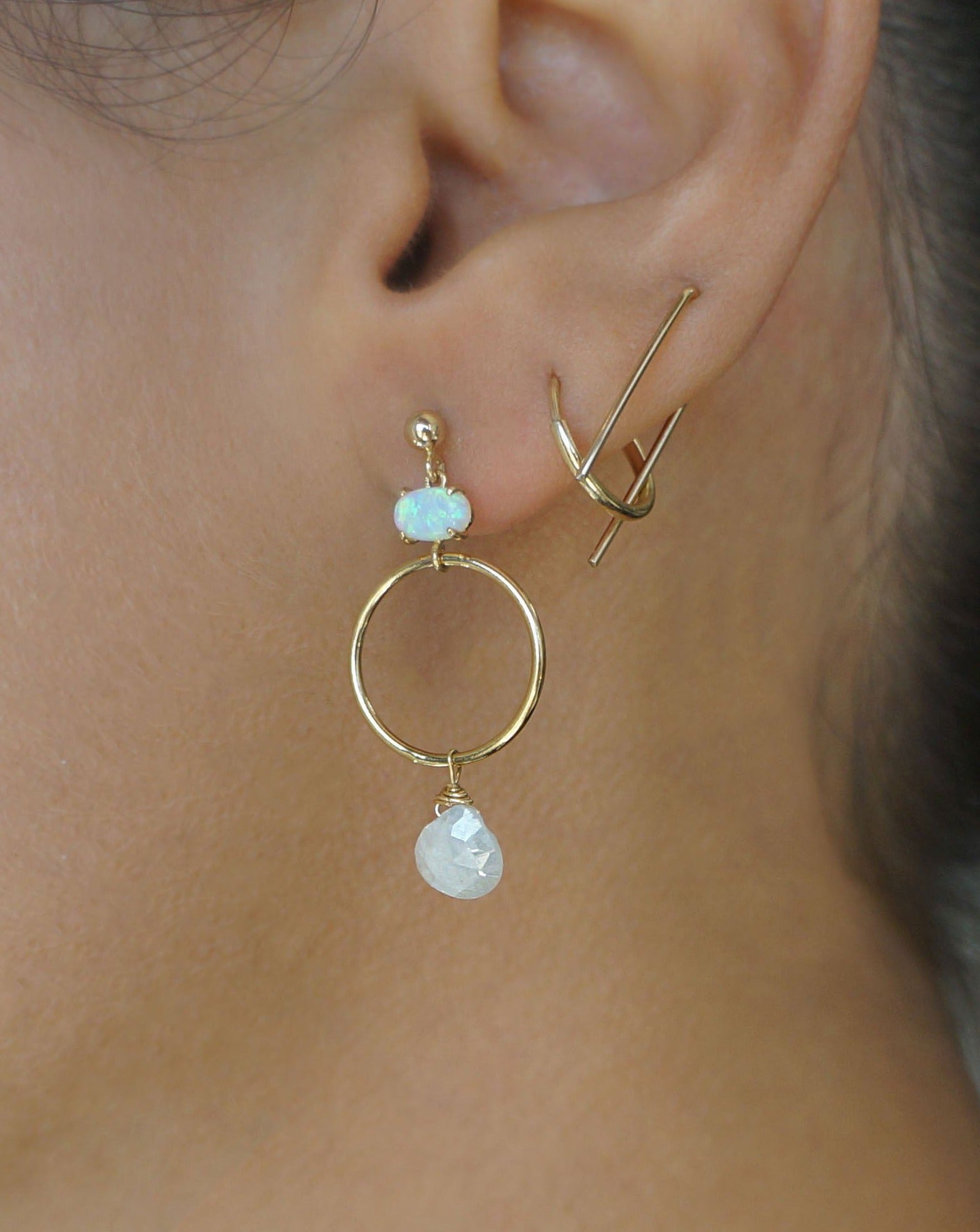 Azuu Earrings by KOZAKH. A 1 1/2 inch dangling earrings in 14K Gold Filled, featuring an Opal charm and a faceted White Sapphire.