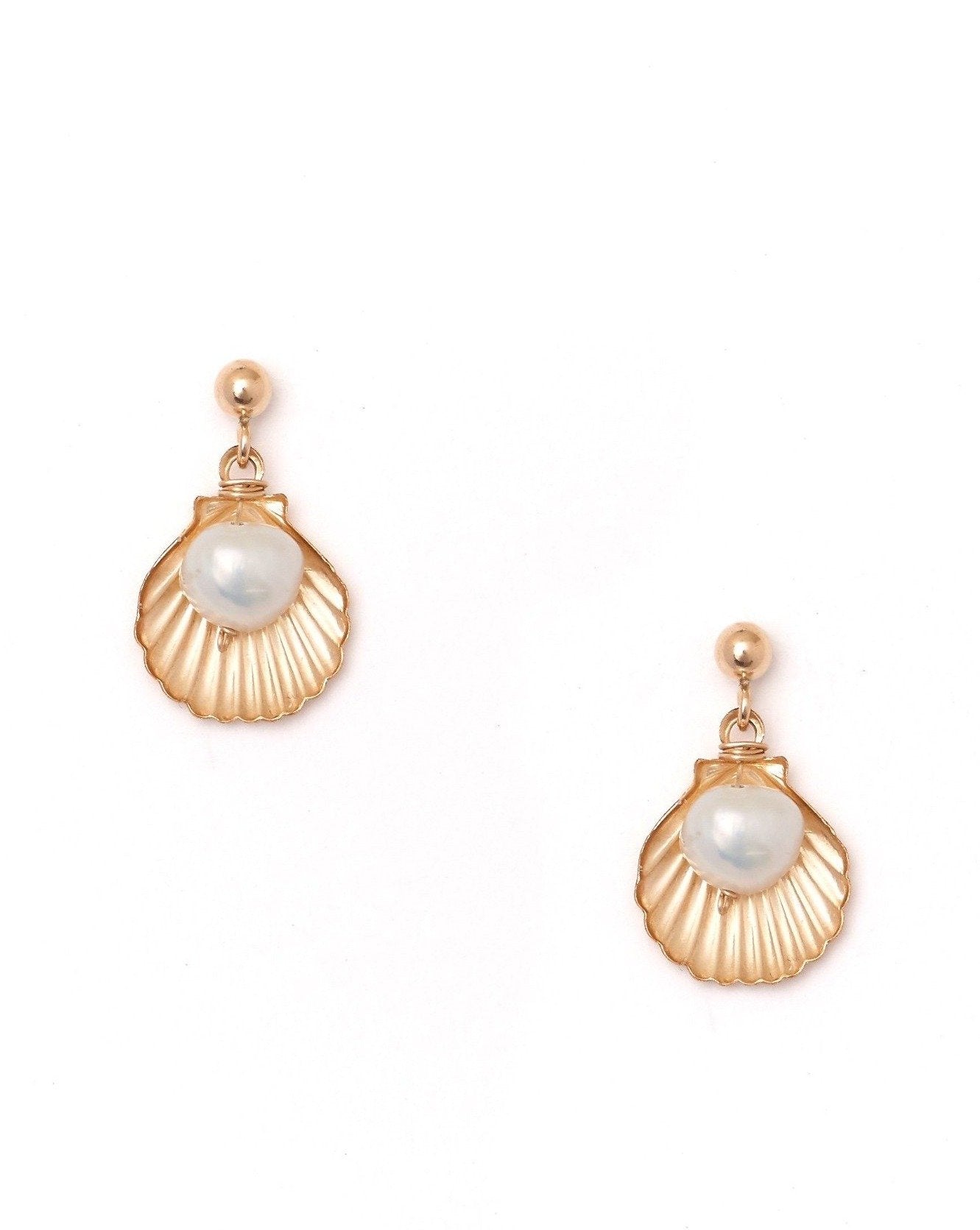 Belle Earrings by KOZAKH. Dangling earrings in 14K Gold Filled, featuring a 5mm flat irregular Pearl and a Shell charm.