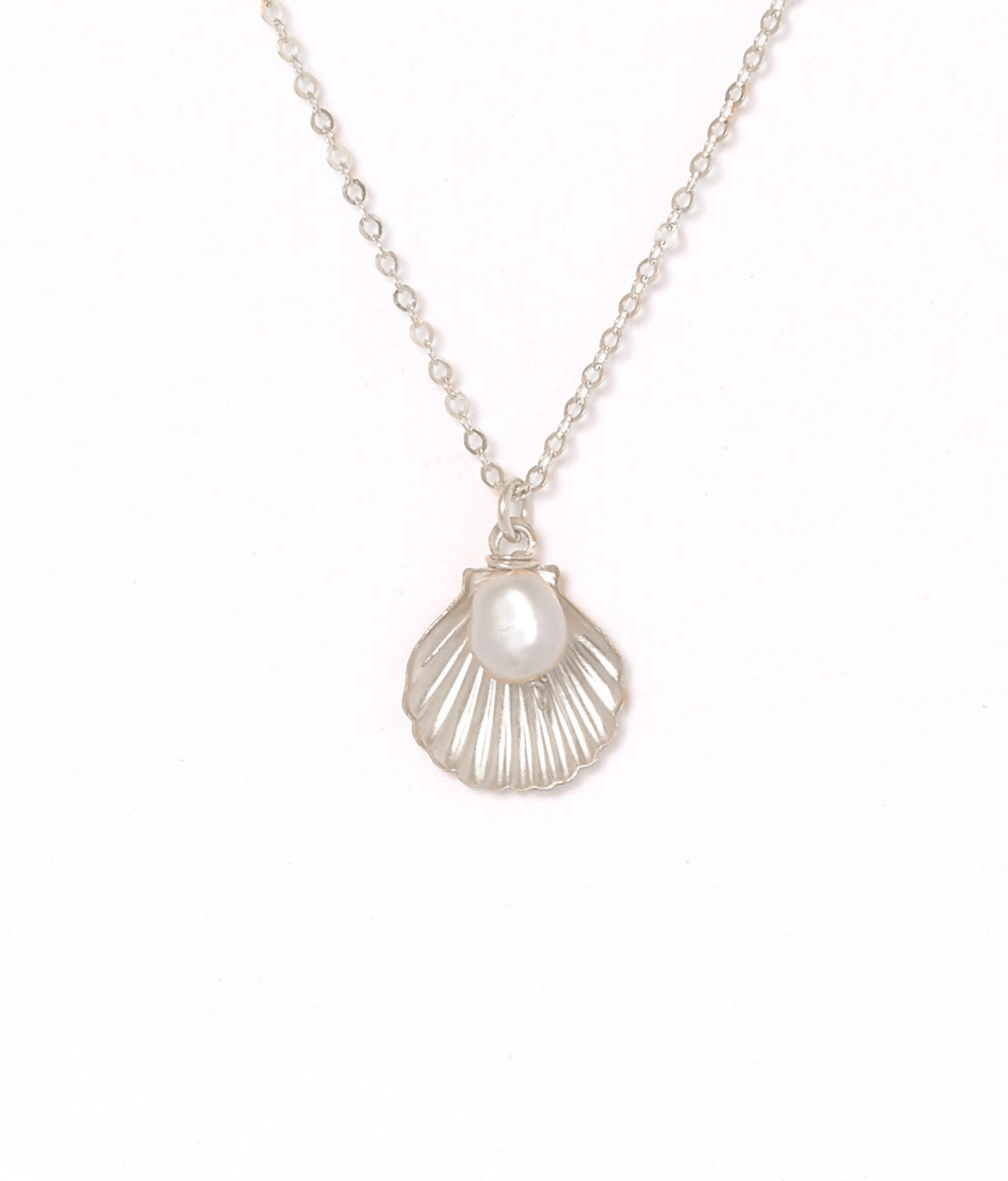 Belle Necklace by KOZAKH. A 16 to 18 inch adjustable length necklace in Sterling Silver, featuring a 5mm flat irregular Pearl and a Shell charm.
