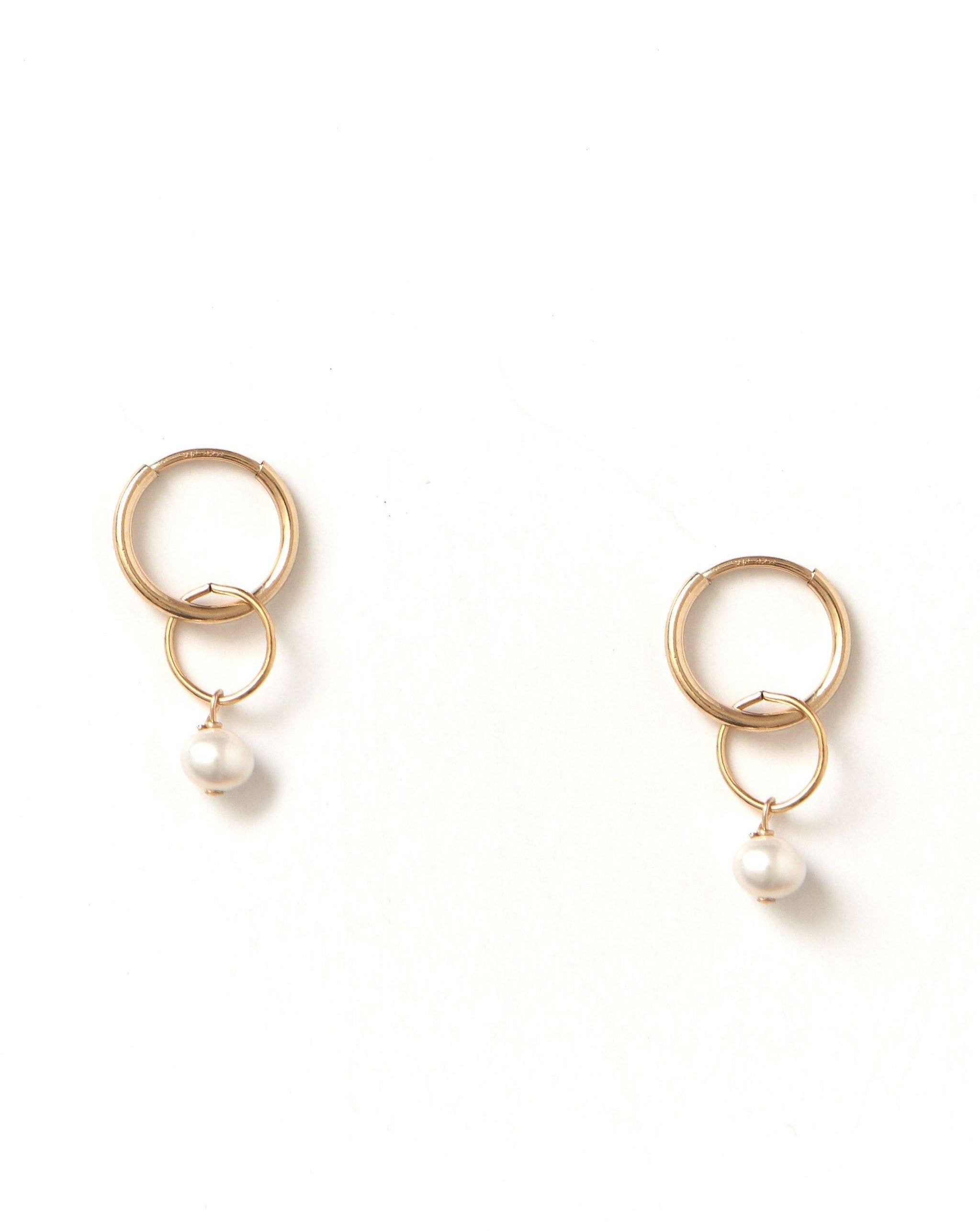 Caen Pearl Hoops by KOZAKH. 12mm hoop earrings, crafted in 14K Gold Filled, featuring 6mm to 7mm Pearls.