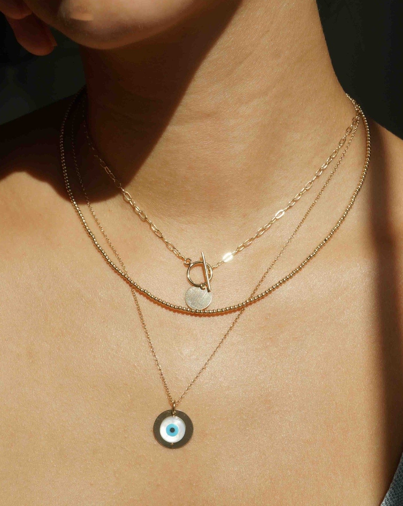 Cappa Necklace by KOZAKH. A 16 to 18 inch adjustable length necklace in 14K Gold Filled, featuring a coin charm.