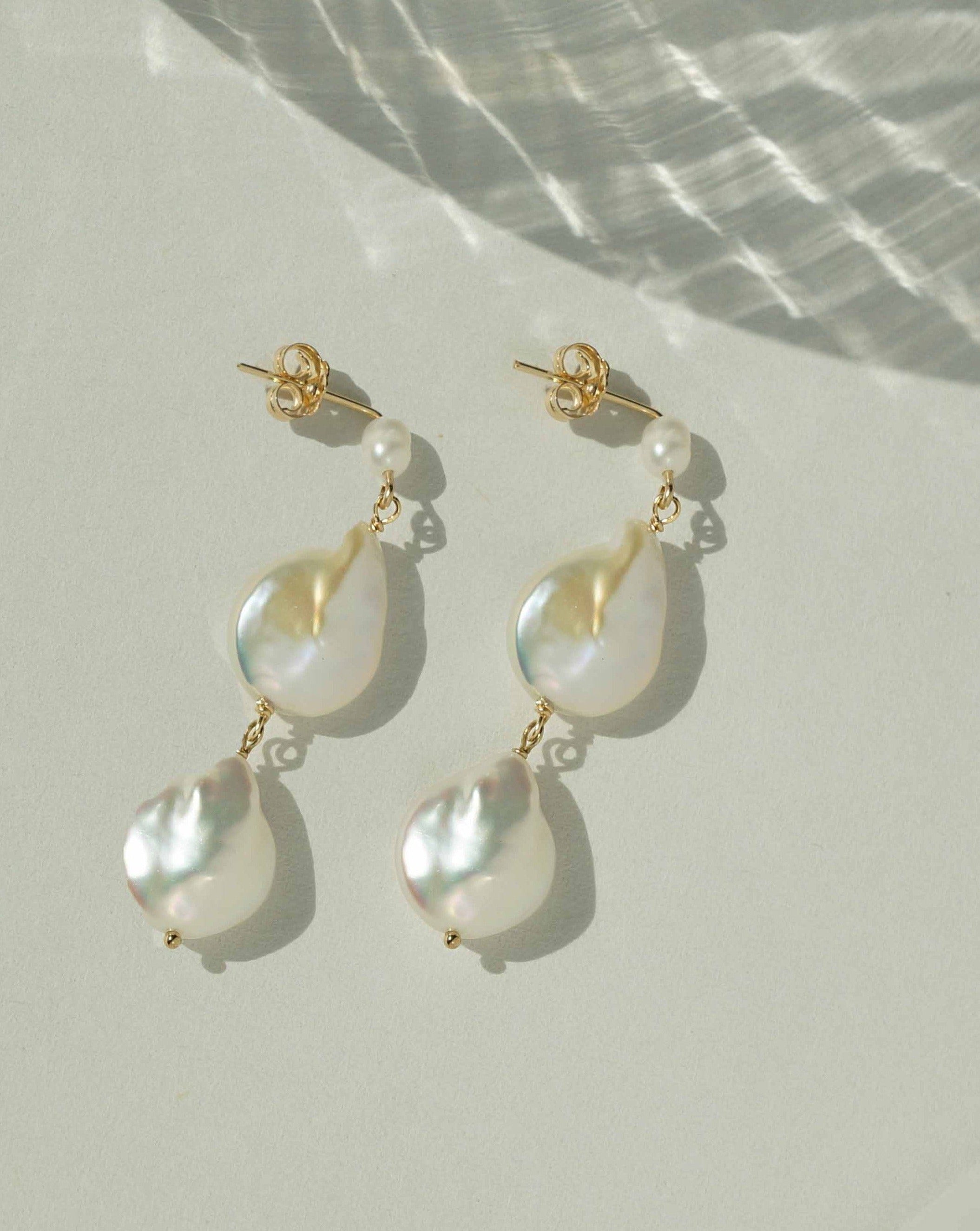 Caro Earrings by KOZAKH. Dangling earrings in 14K Gold Filled with an earring drop length of 2 inches, featuring Freshwater Baroque Pearls.