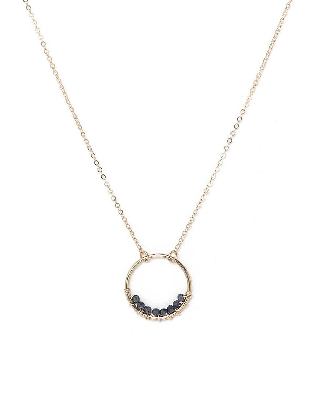 Curra Necklace by KOZAKH. A 16 to 18 inch adjustable length necklace in 14K Gold Filled, featuring a ring with 2mm faceted round Sapphire gems.