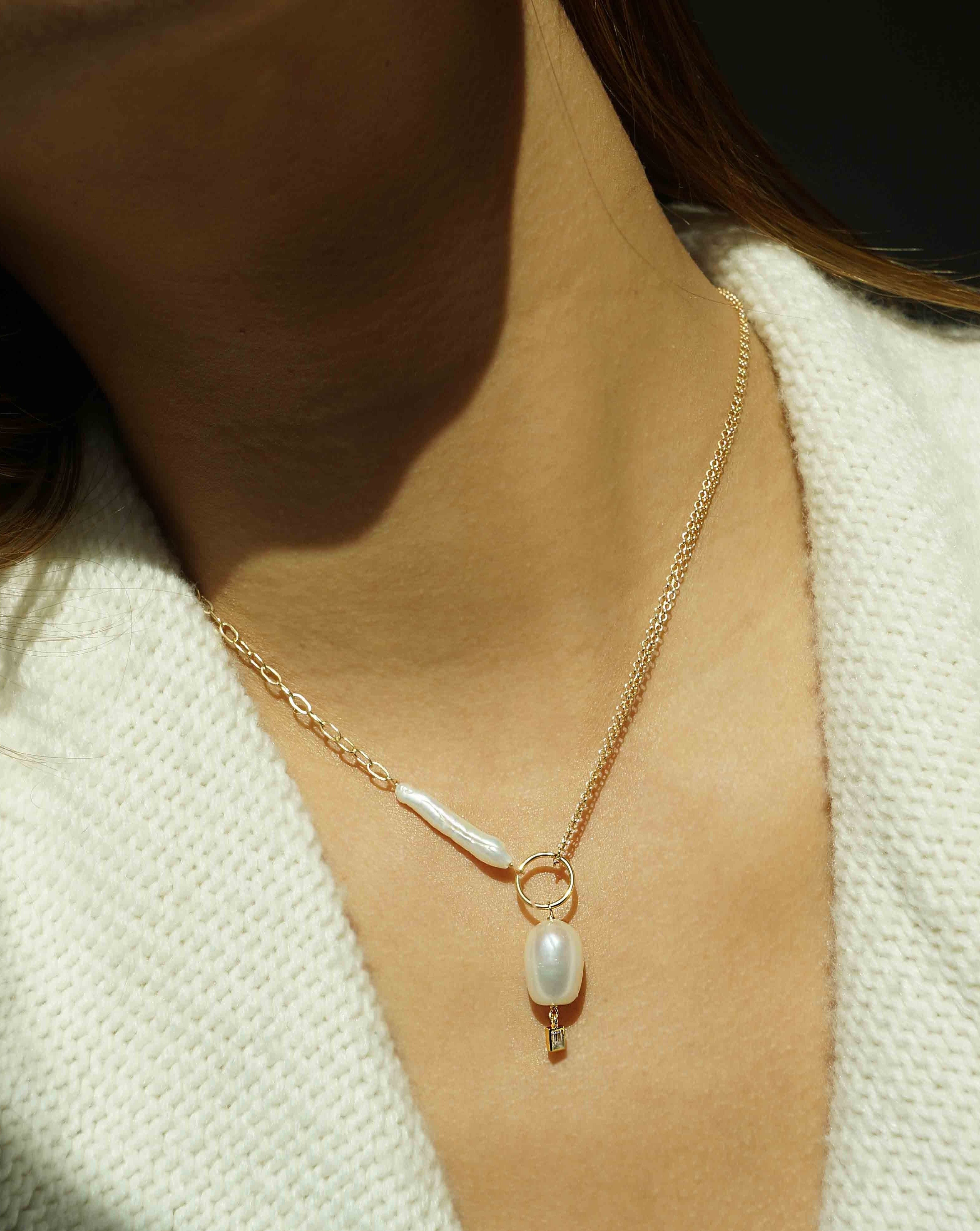 Darita Necklace by KOZAKH. A 16 to 18 inch adjustable length necklace in 14K Gold Filled, featuring a Biwa Pearl, a 6x9mm white oval shaped Pearl, and a 3mm rectangle cut Cubic Zirconia.