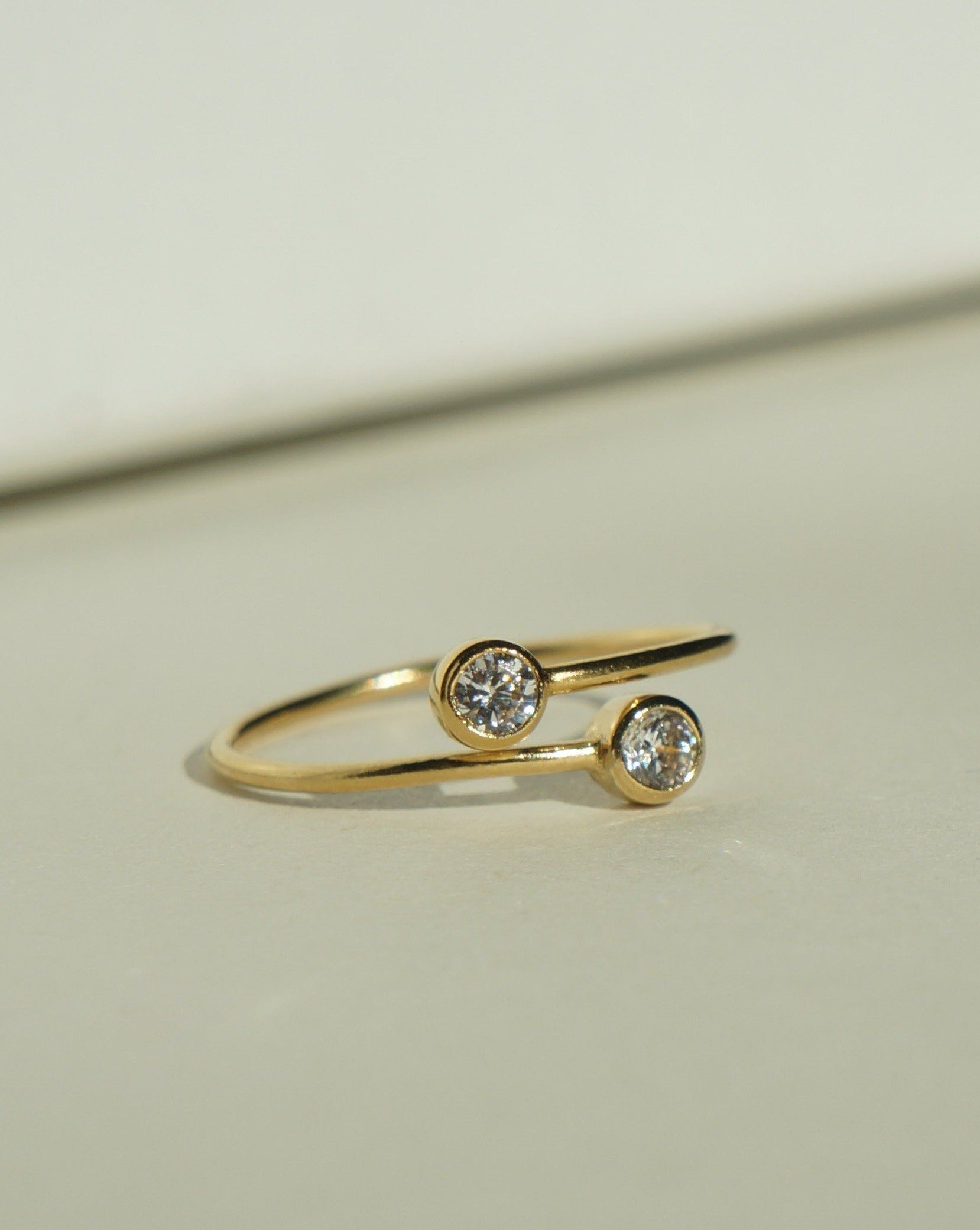 Dos Dia Ring by KOZAKH. A 1mm thick ring, crafted in 14K Gold Filled, featuring two 2mm Cubic Zirconia bezel.