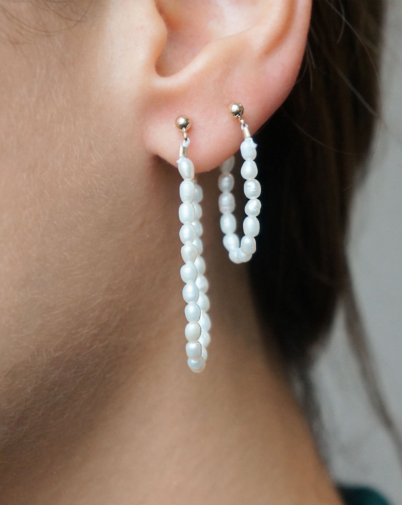 Dream Earrings by Kozakh. 3mm ball earring stud, crafted in 14K Gold Filled, featuring a 1 inch drop length of 3mm white Rice Pearls.