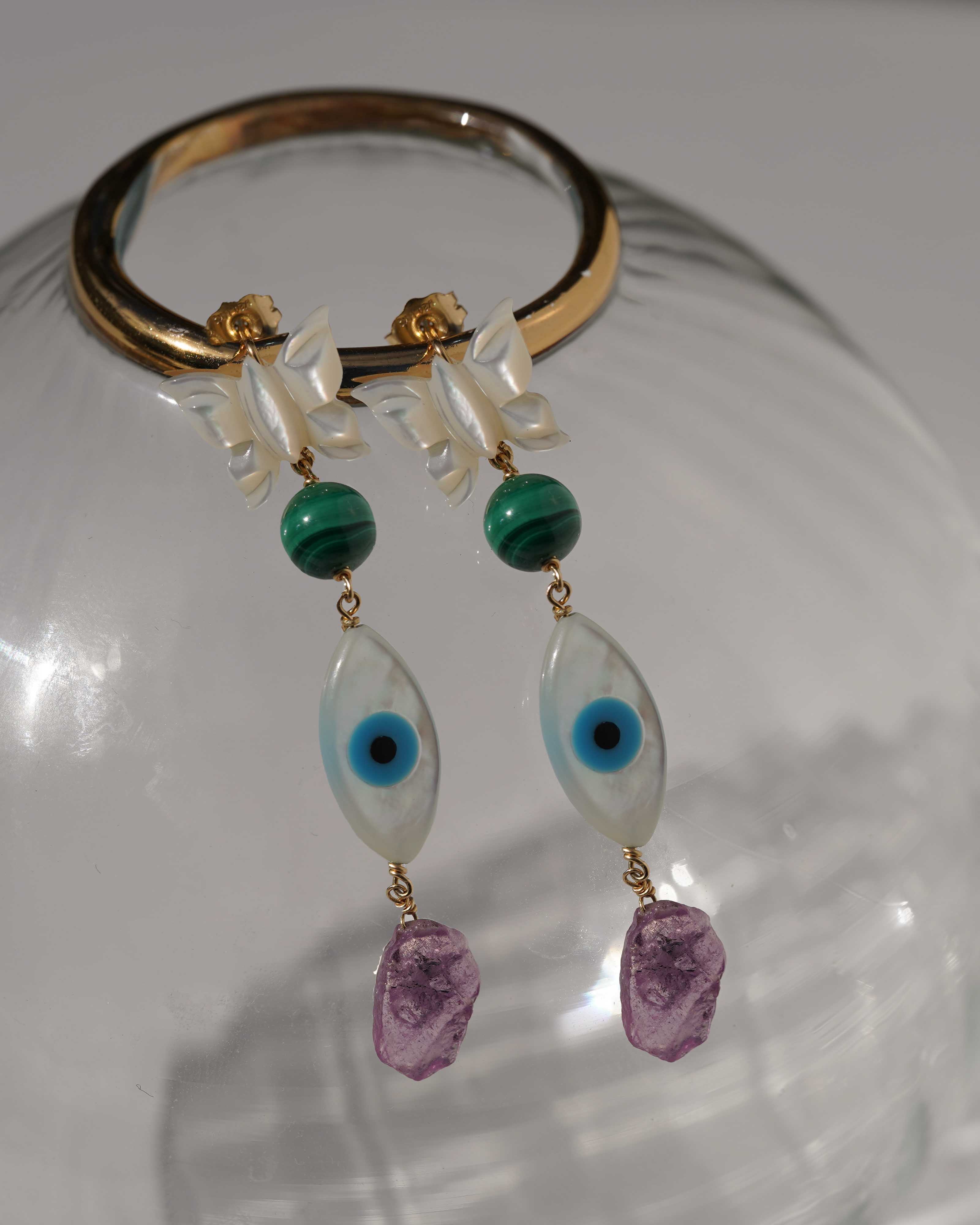 Dulce Earrings by KOZAKH. 3 inch drop dangling earrings, crafted in 14K Gold Filled, featuring a Mother of Pearl Butterfly charm, a round cut Malachite, a hand-carved Mother of Pearl eye charm, and a Pink Tourmaline shard.