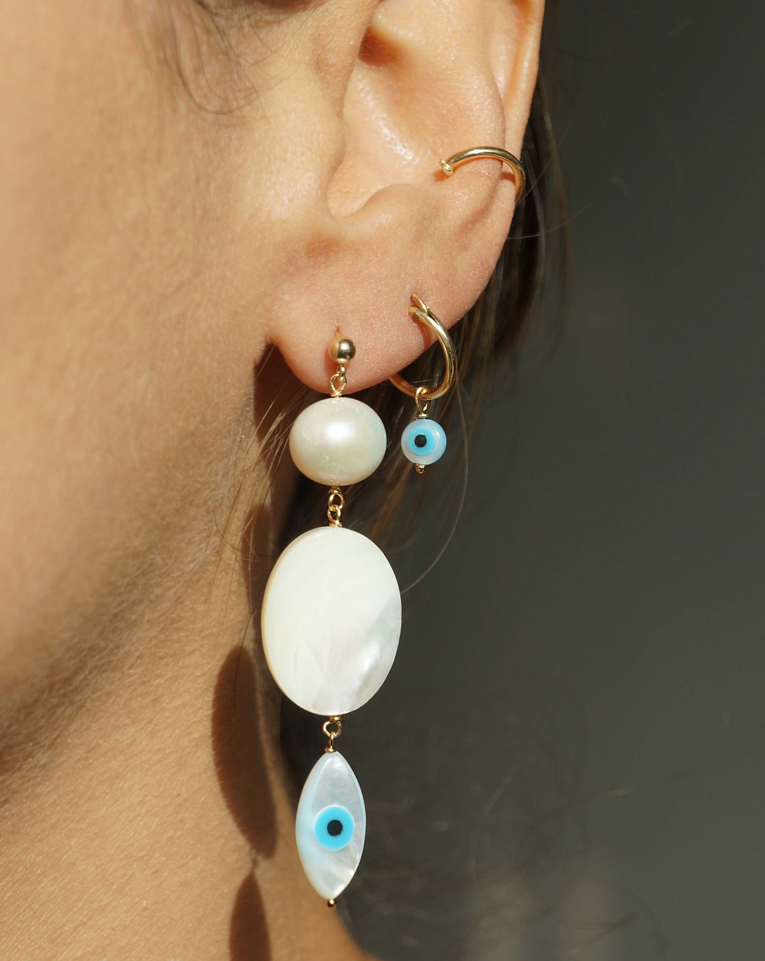 Ellie Hoops by Kozakh. 12mm hoop earrings, crafted in 14K Gold Filled, featuring a Mother of Pearl Evil Eye.