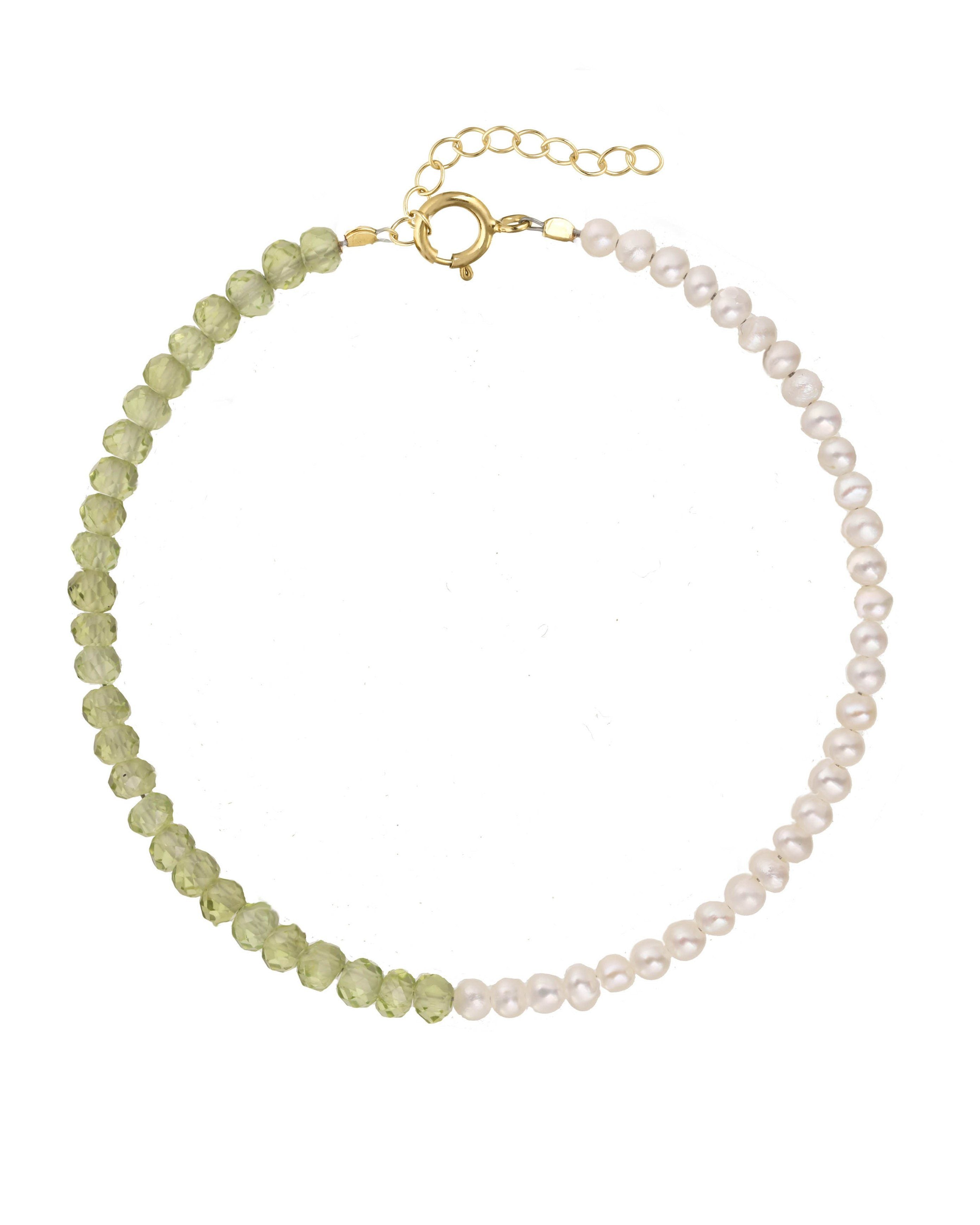 Elo Bracelet by KOZAKH. A 6 to 7 inch adjustable length bracelet, crafted in 14K Gold Filled. Half of the bracelet strand features 3.5mm Freshwater Pearls and 3.5mm Faceted Peridot beads on the other half.
