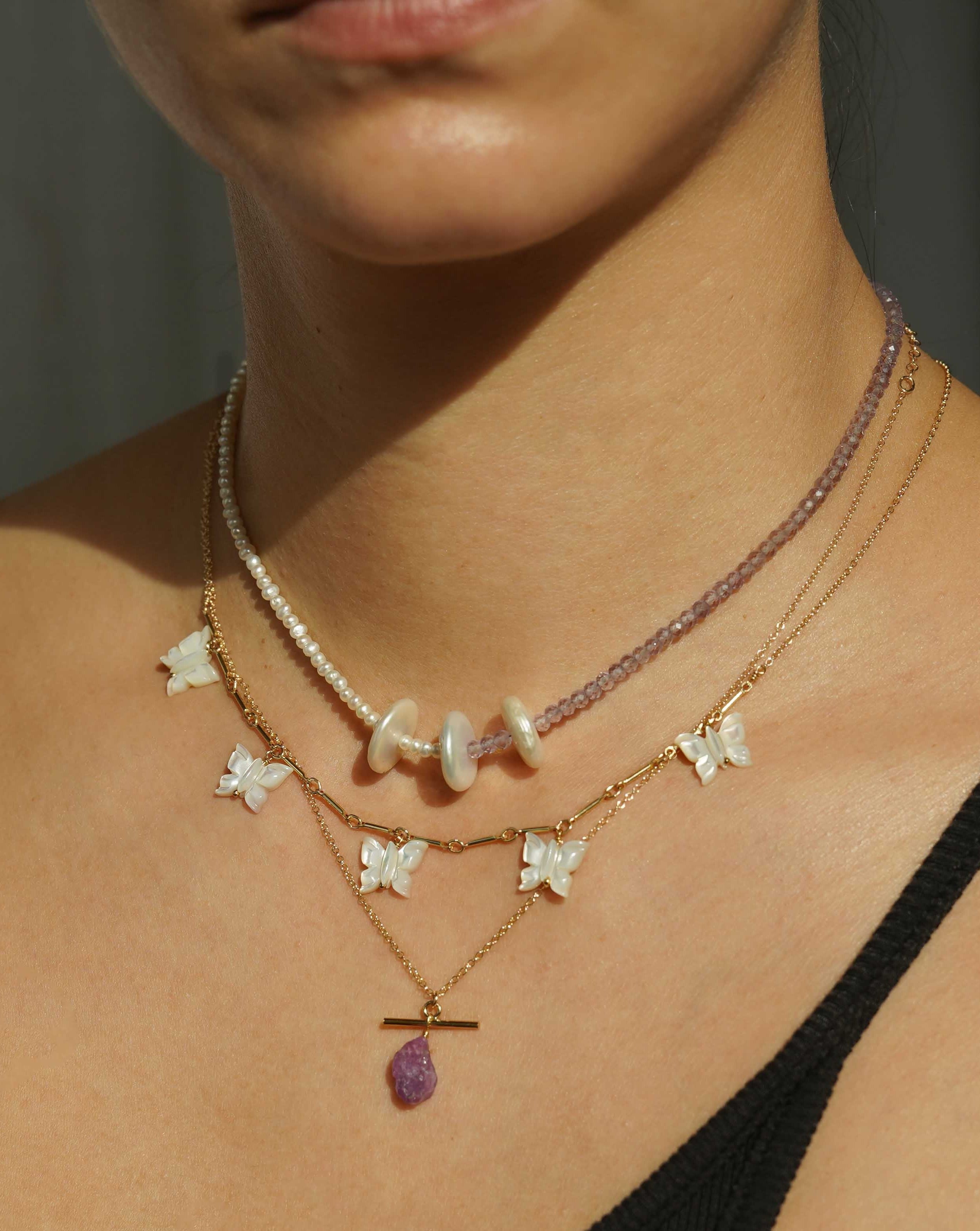 Fallon Necklace by KOZAKH. A 16 to 18 inch adjustable length, bar link chain necklace in 14K Gold Filled, featuring hand-carved Mother of Pearl butterfly charms. 