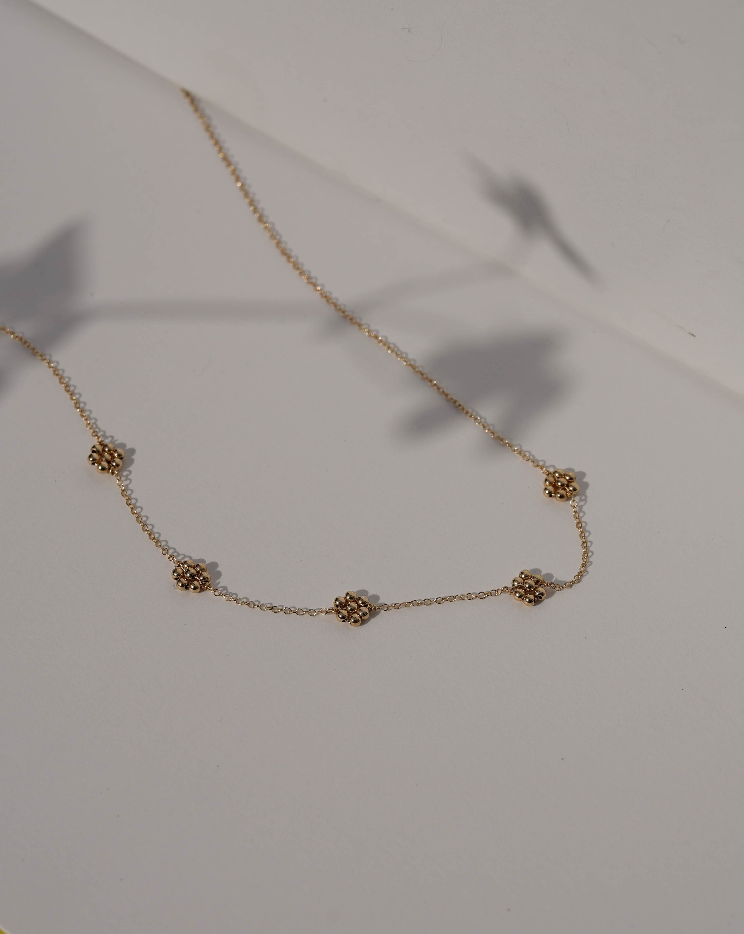Florencia Necklace by KOZAKH. A 16 to 18 inch adjustable length necklace in 14K Gold Filled, featuring handmade gold beaded daisies.