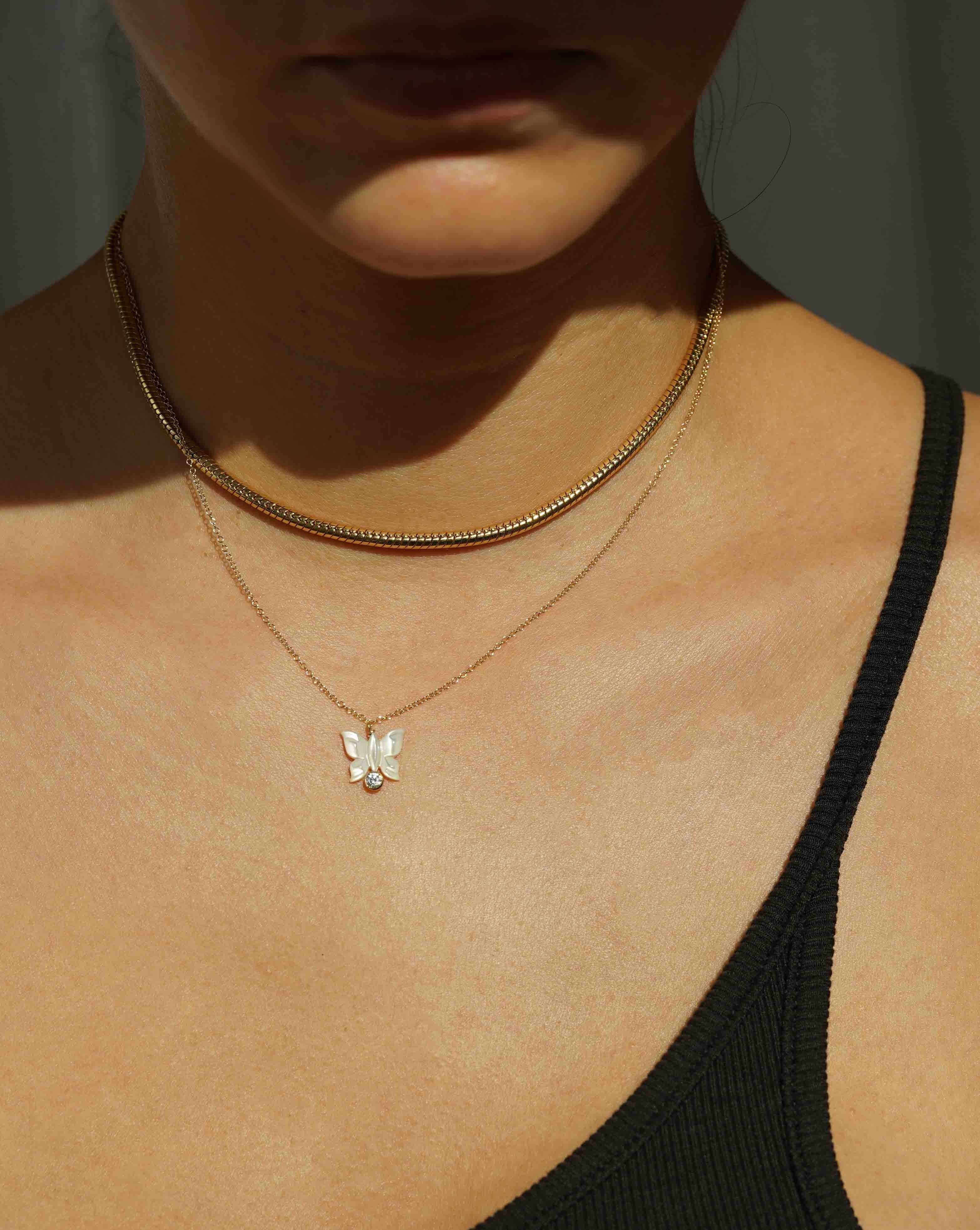 Halo Necklace by KOZAKH. A 16 to 18 inch adjustable length necklace in 14K Gold Filled, featuring a hand-carved Mother of Pearl butterfly charm and a 3mm Cubic Zirconia bezel.