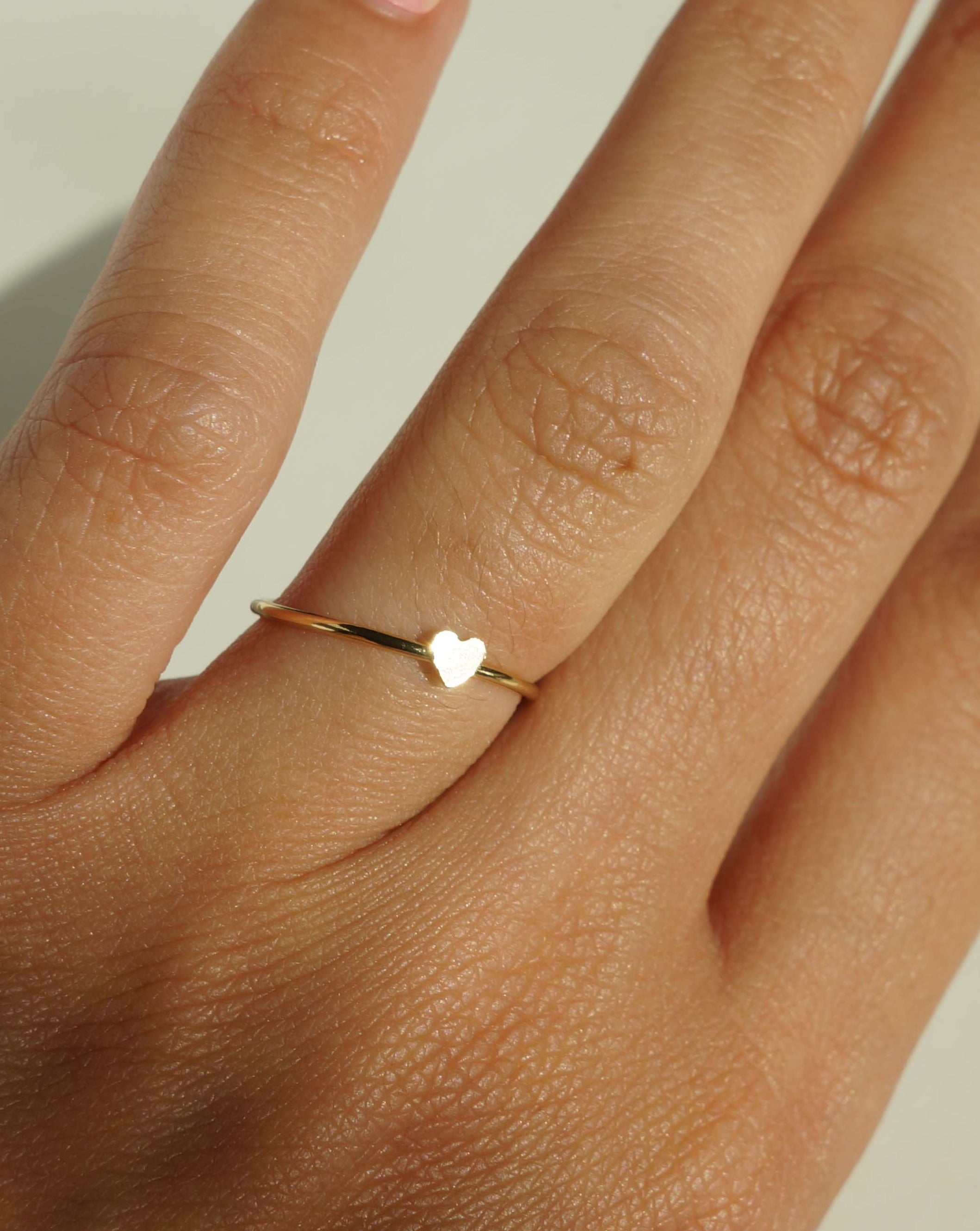 Heart Ring by KOZAKH. A 1mm band, crafted in 14K Gold Filled, featuring a gold heart design.