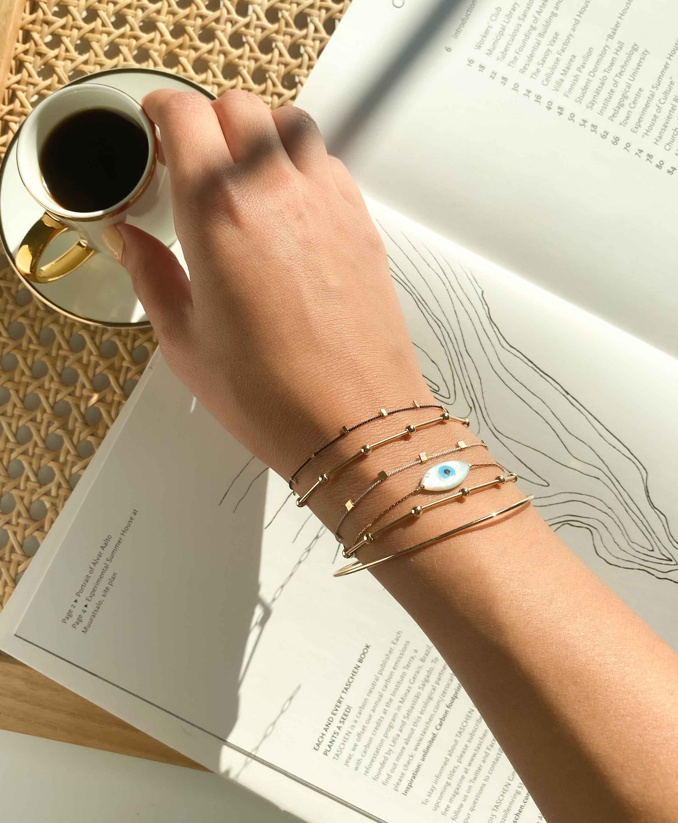 Hilo Bracelet by KOZAKH. A 6 to 7 inch adjustable length natural silk thread bracelet, embellished with 14K Gold Filled metals.