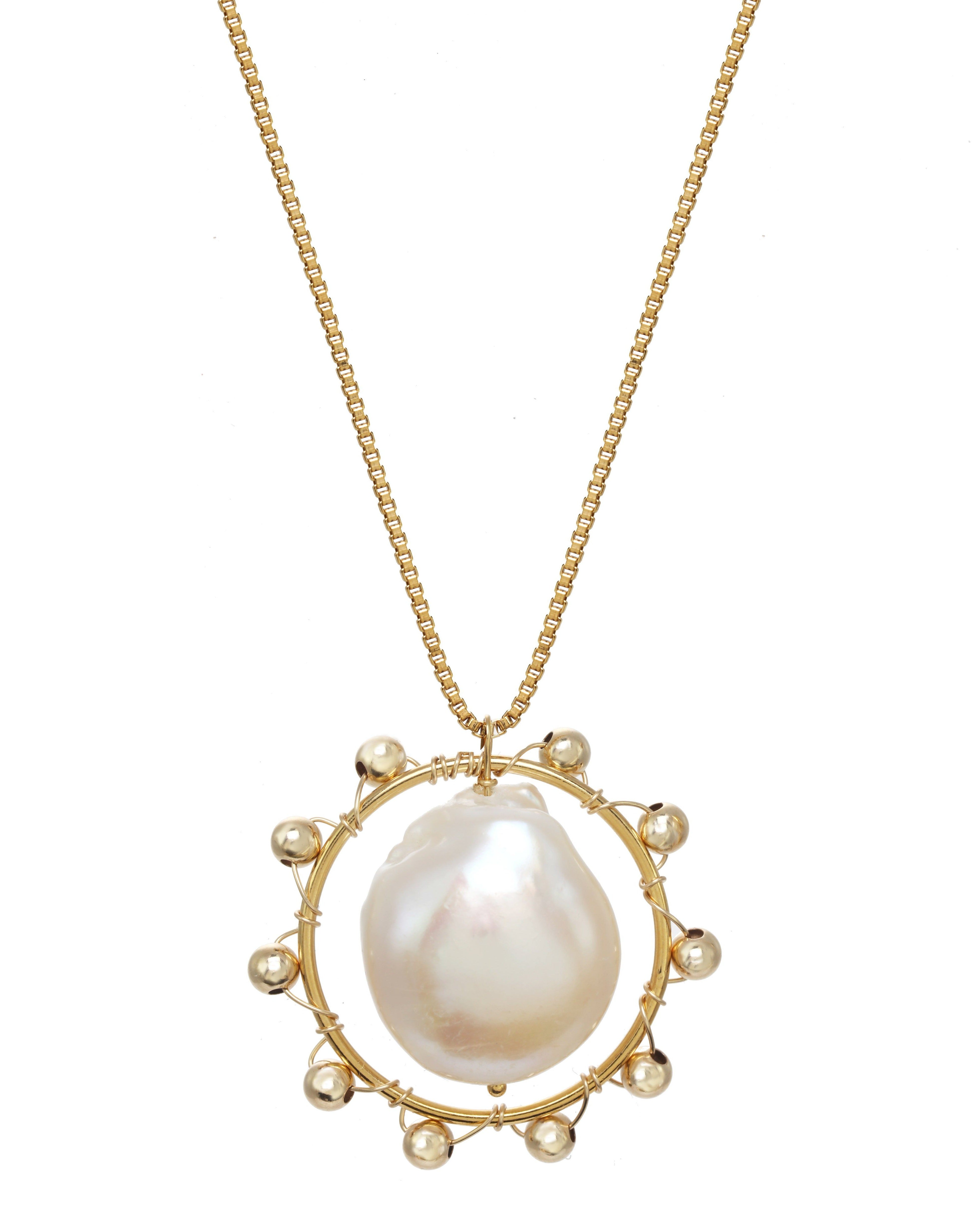 Kuru Necklace by KOZAKH. A 16 to 18 inch adjustable length, 1mm box chain necklace, crafted in 14K Gold Filled, featuring a 20mm x 15mm Baroque Pearl inside a ring embellished with gold beads.