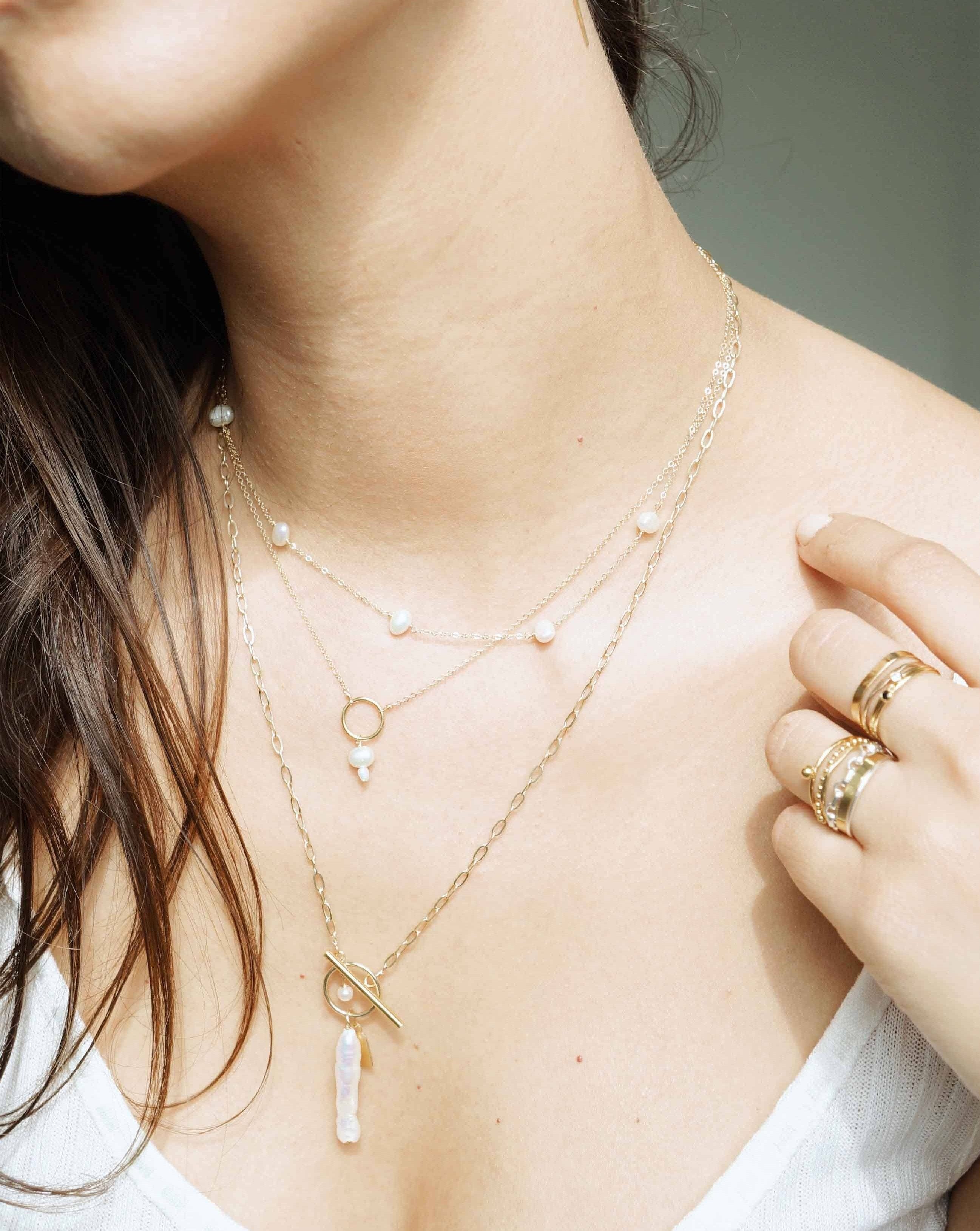 Lahela Necklace by KOZAKH. A 16 to 18 inch adjustable length necklace, crafted in 14K Gold Filled, featuring a 4-5mm White irregular Pearl and a 3-4mm white freshwater Pearl.