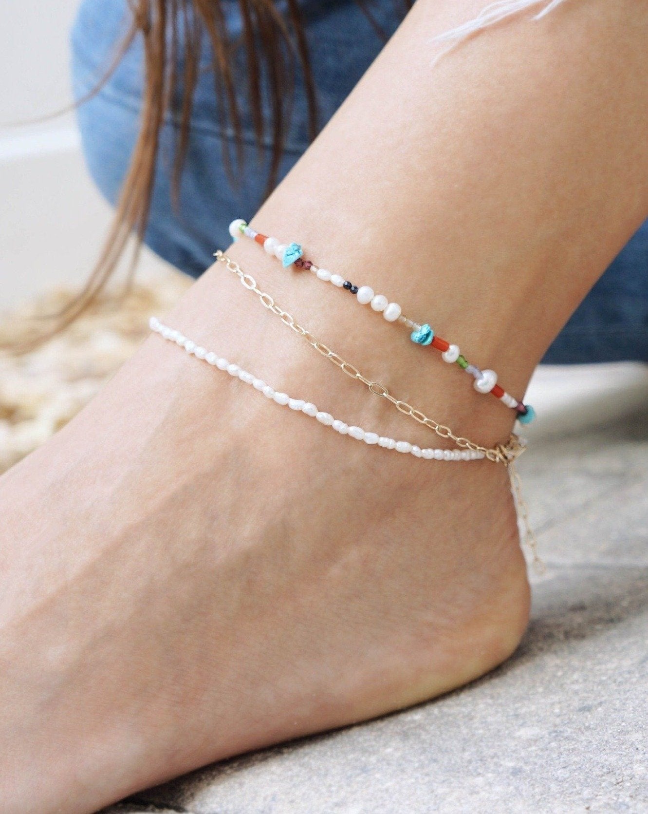 Lamera Anklet by KOZAKH. A 9 to 11 inch adjustable length double anklet. One strand is 14K Gold Filled flat link chain and the other is a strand of 4mm white Rice Pearls.