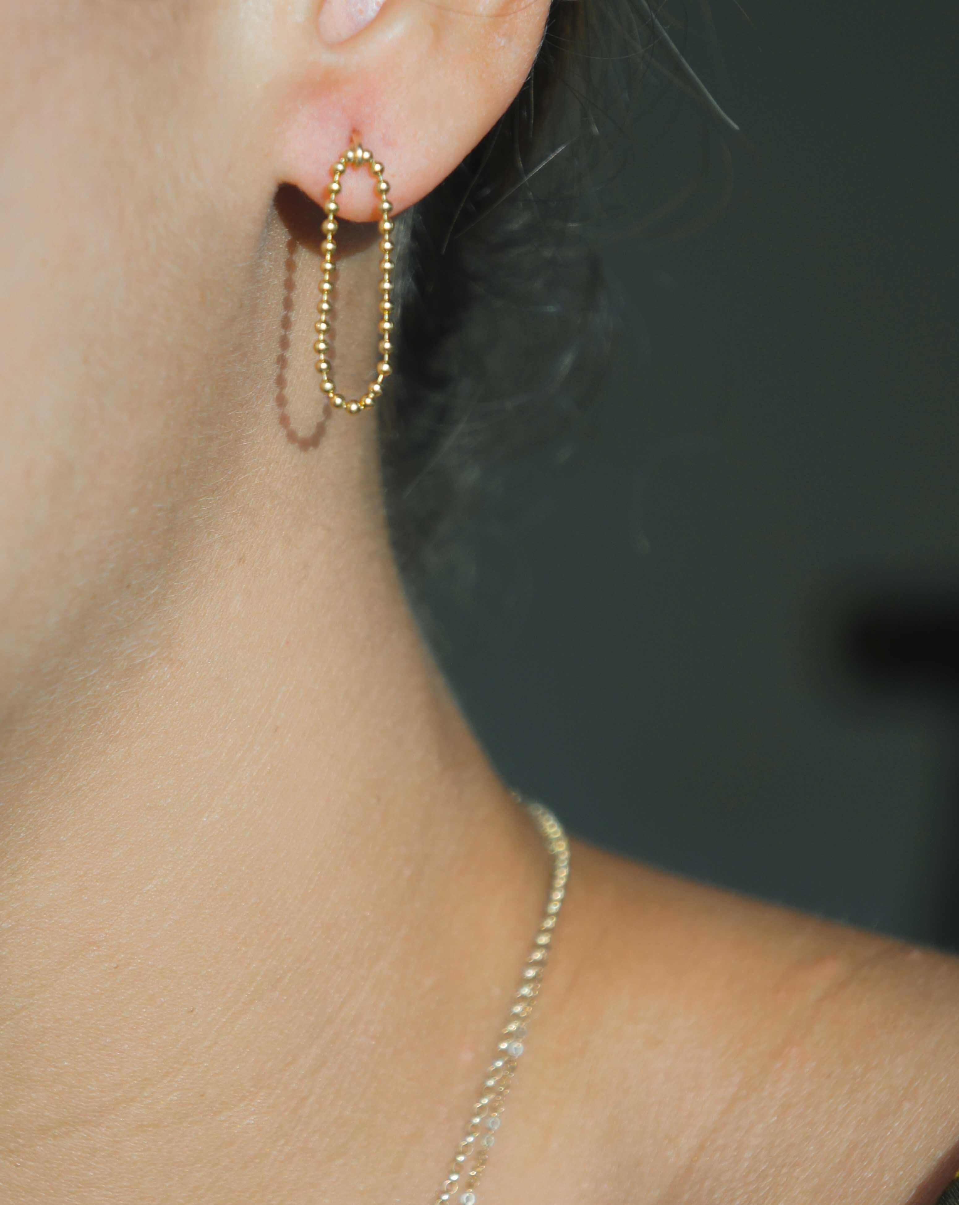 Lata Earrings by KOZAKH. 14K Gold Filled drop style stud earrings, with drop length of 1 inch, featuring linked gold balls.