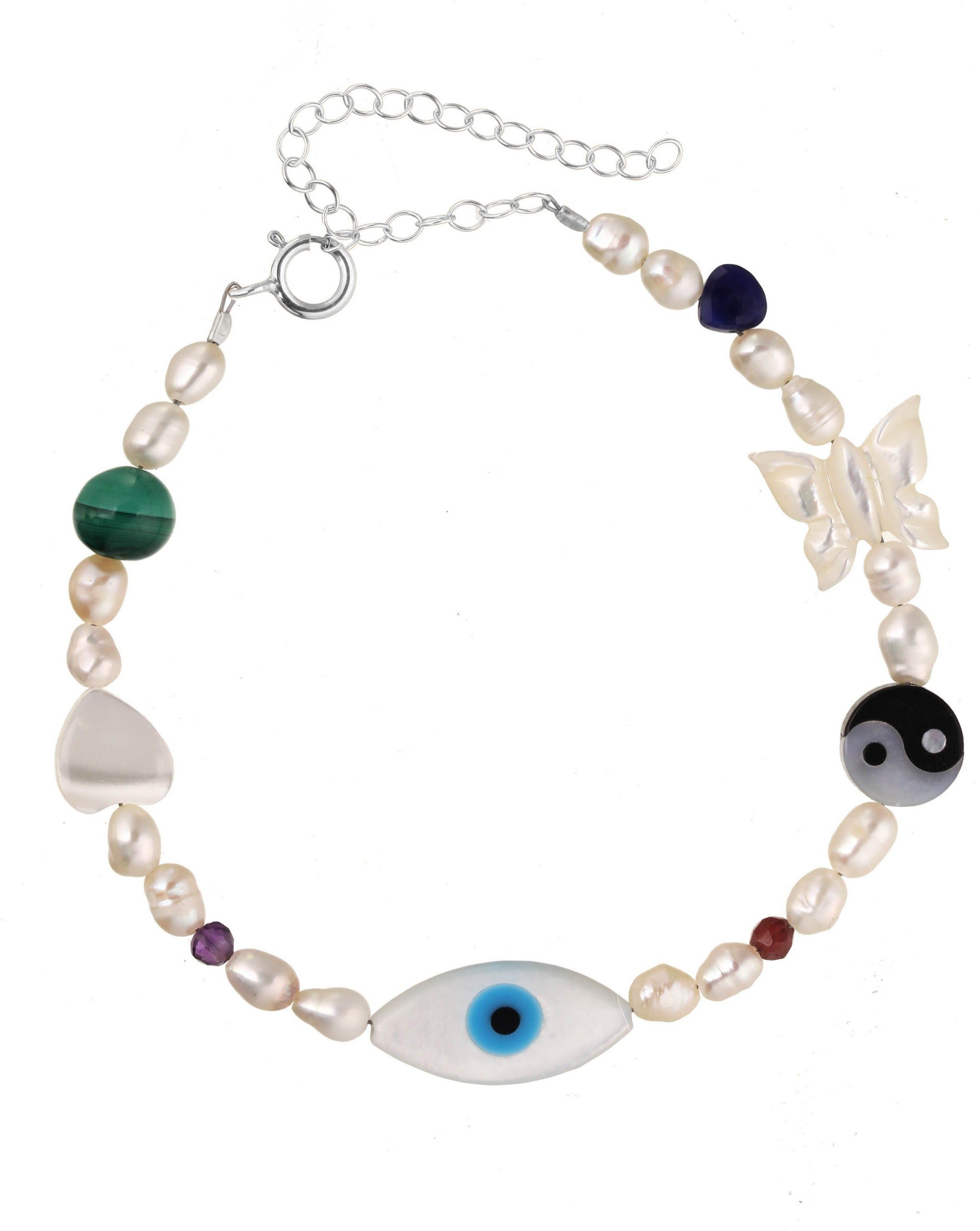 Lexie Bracelet by KOZAKH. A 6 to 7 inch adjustable length bracelet in Sterling Silver, featuring Pink Tourmaline slice, Mother of Pearl butterfly charm, round cut Malachite gemstone, Mother of Pearl eye charm, and 2.5mm to 3mm Fresh water pearls.