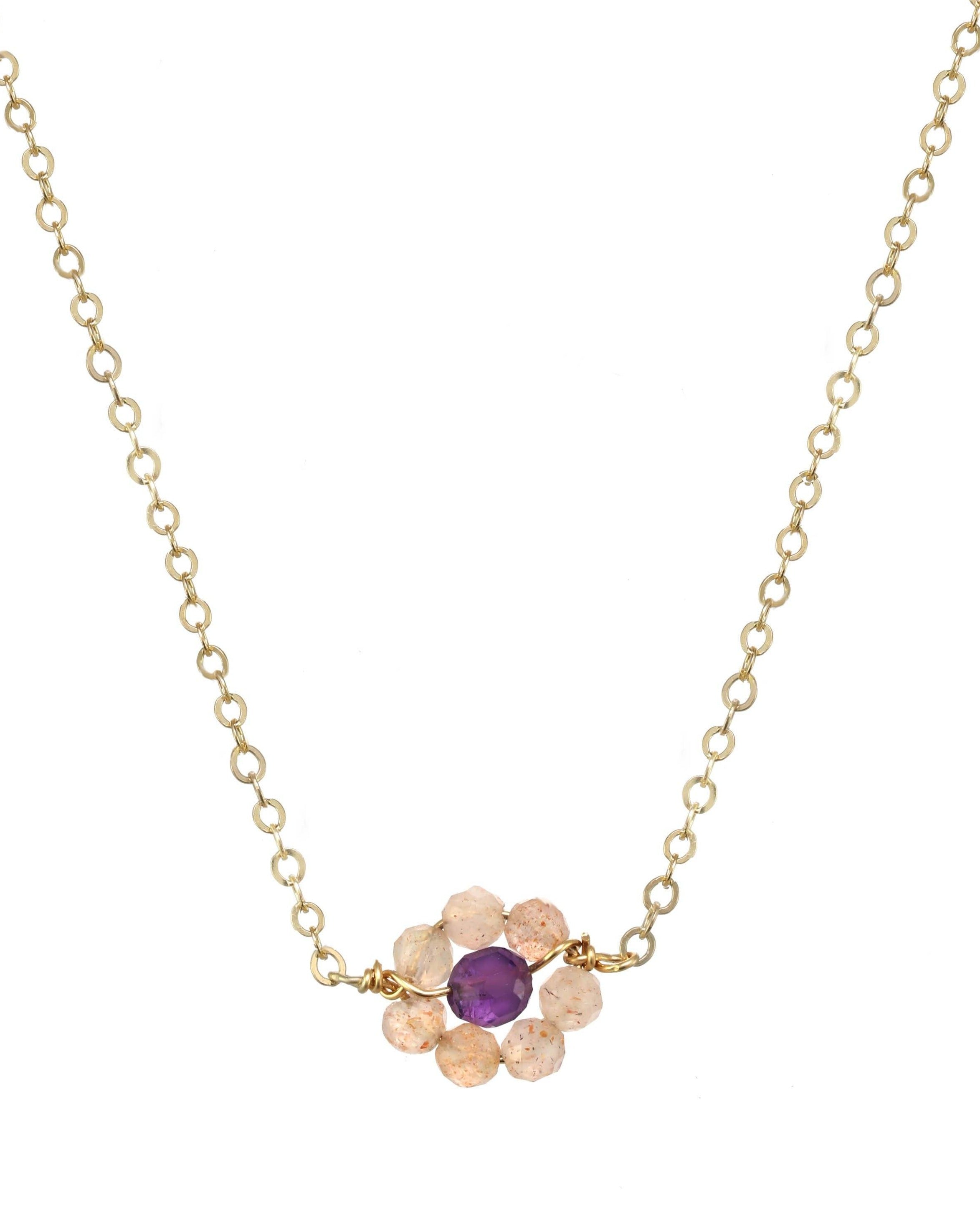 Little Hill Necklace by KOZAKH. A 16 to 18 inch adjustable length necklace, crafted in 14K Gold Filled, featuring 2mm faceted Imperial Topaz gems and a 3mm  faceted Garnet forming a flower charm.