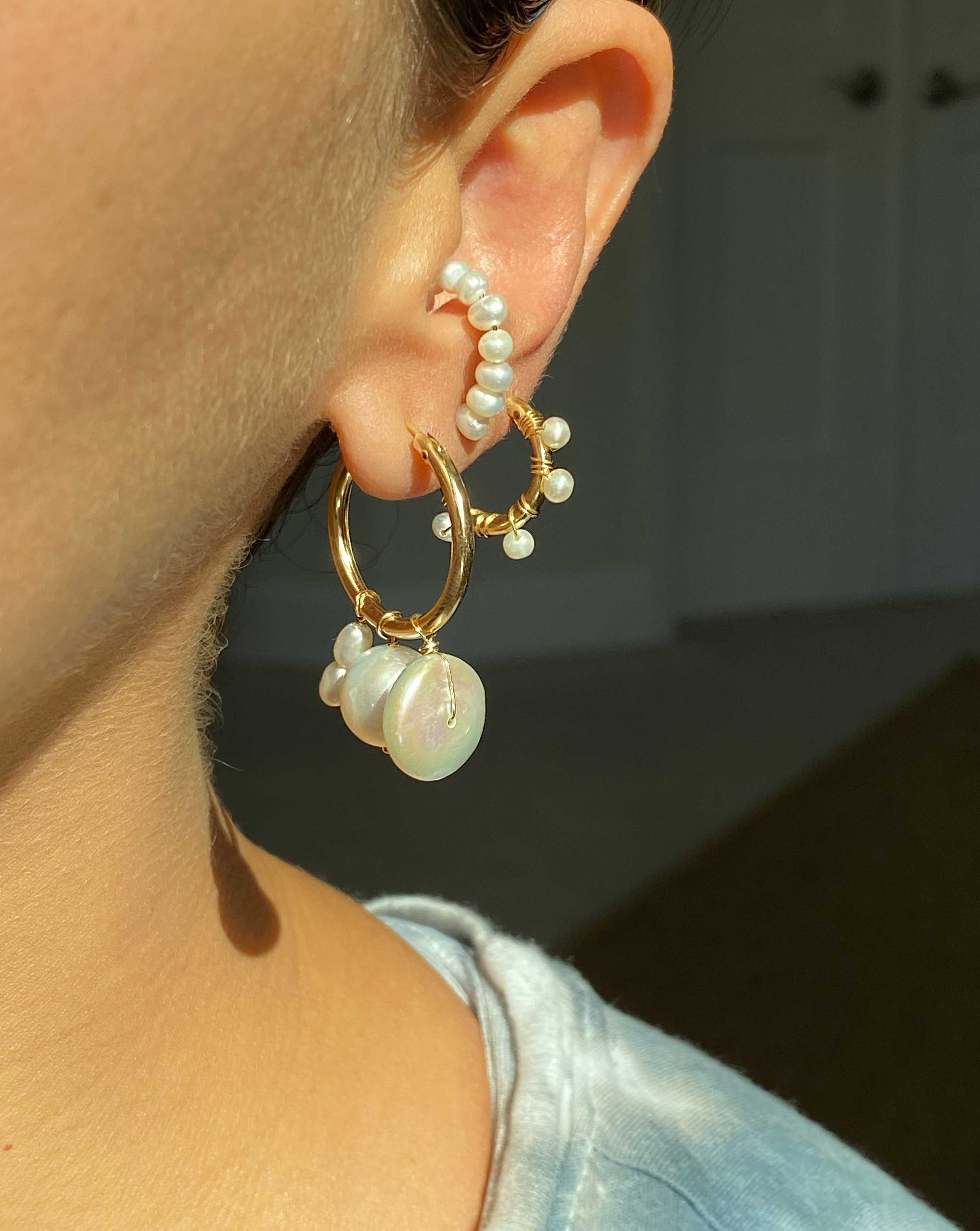 Lolo Hoops by KOZAKH. Stud earrings crafted in 14K Gold Filled, featuring 3mm white freshwater Pearls forming a hoop shape.
