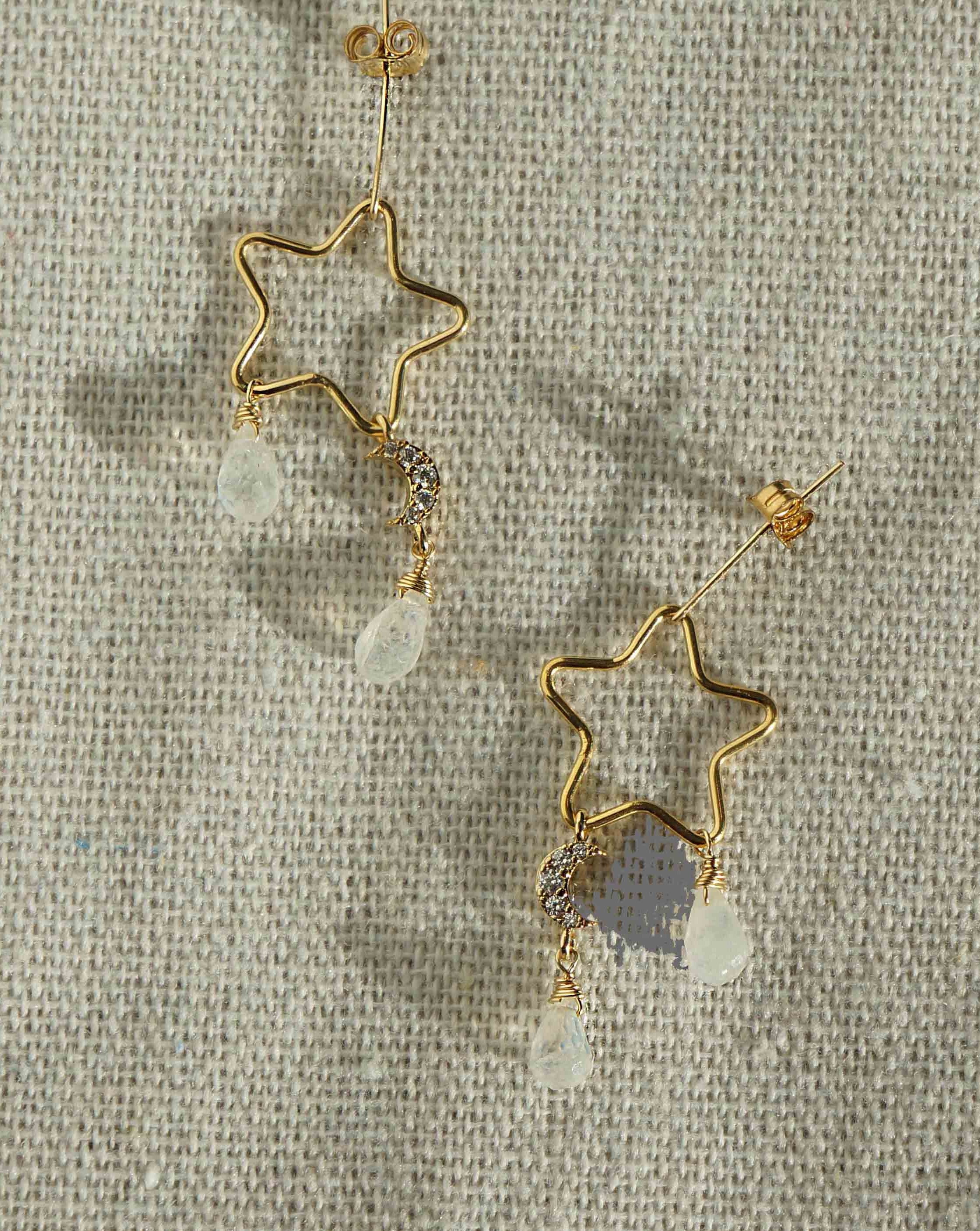 Lyra Earrings by KOZAKH. Dangling style stud earrings crafted in 14K Gold Filled, featuring a star wire charm, faceted Moonstone droplets, and a Cubic Zirconia encrusted moon charm.